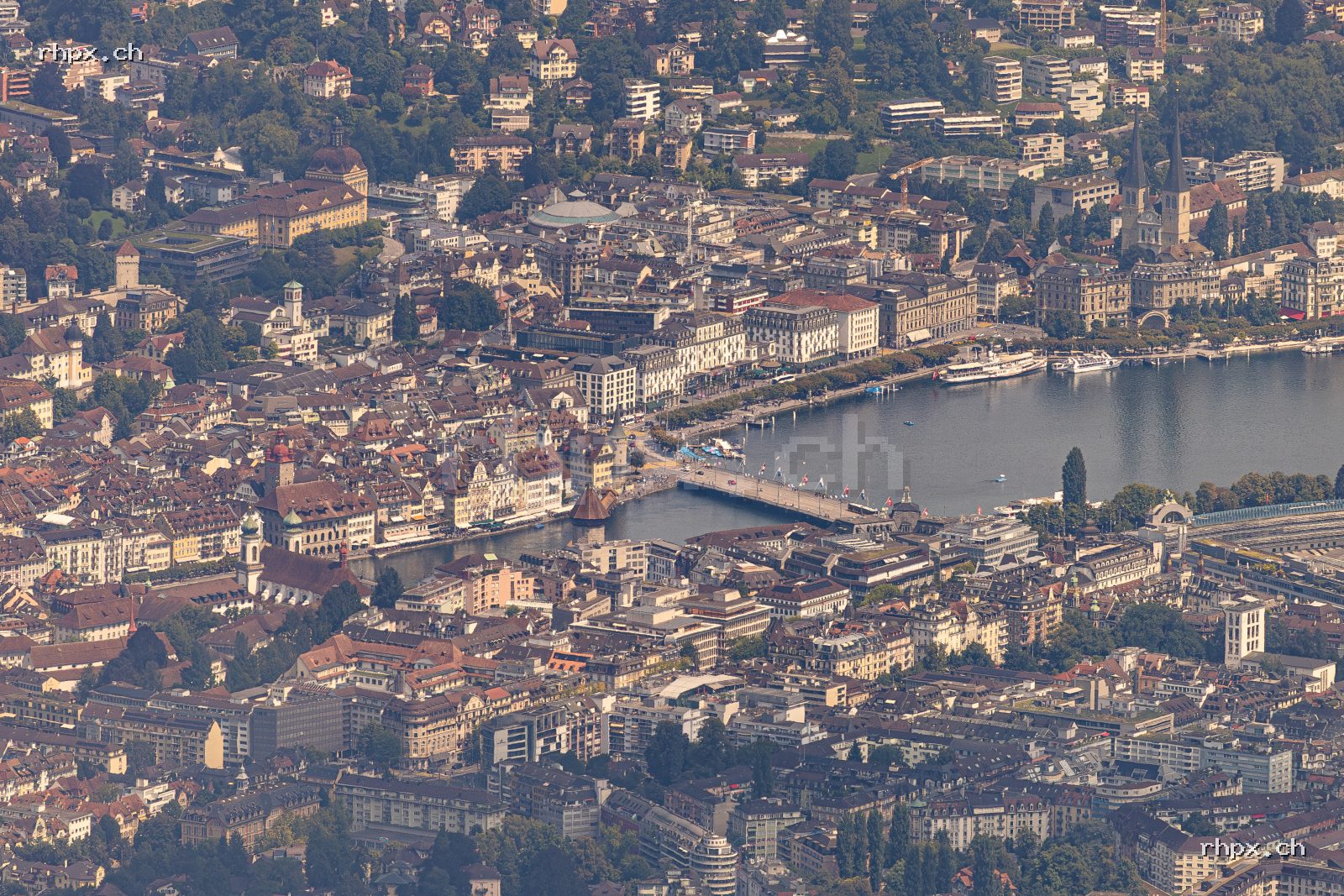 Aerial view of Lucerne by day showing Chapel Bridge, Water Tower, Reuss river and Lake Lucerne, photographed from Mount Pilatus