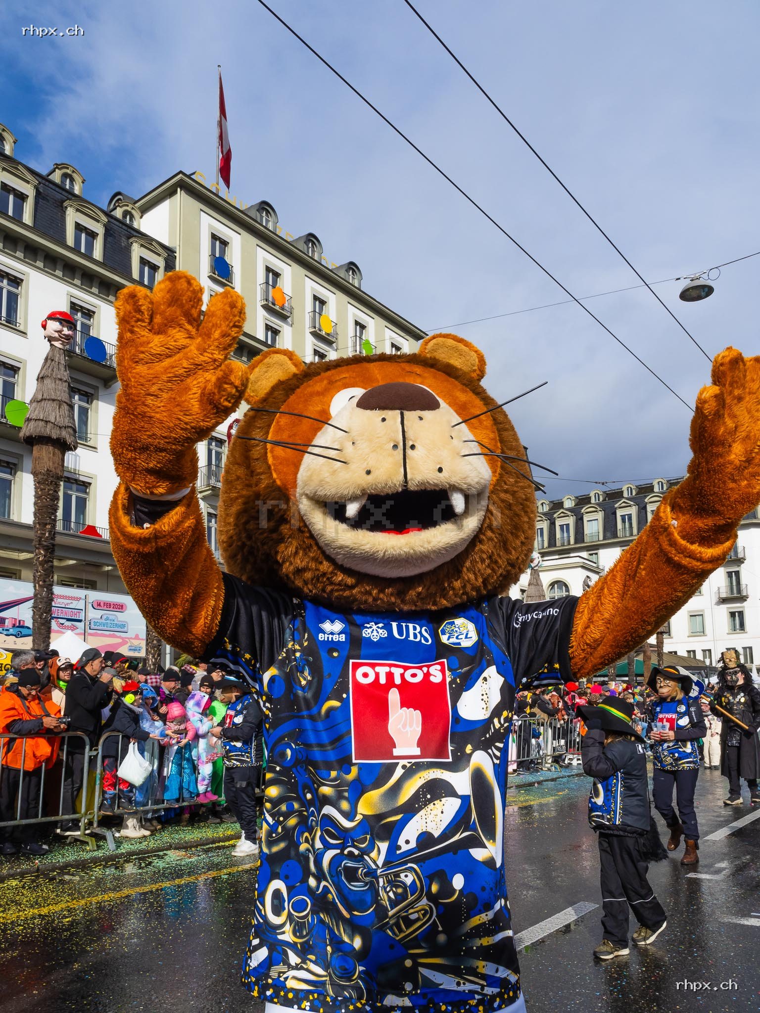 Members of a carnival band in Lucerne with brass instruments, drums, masks and colourful costumes.