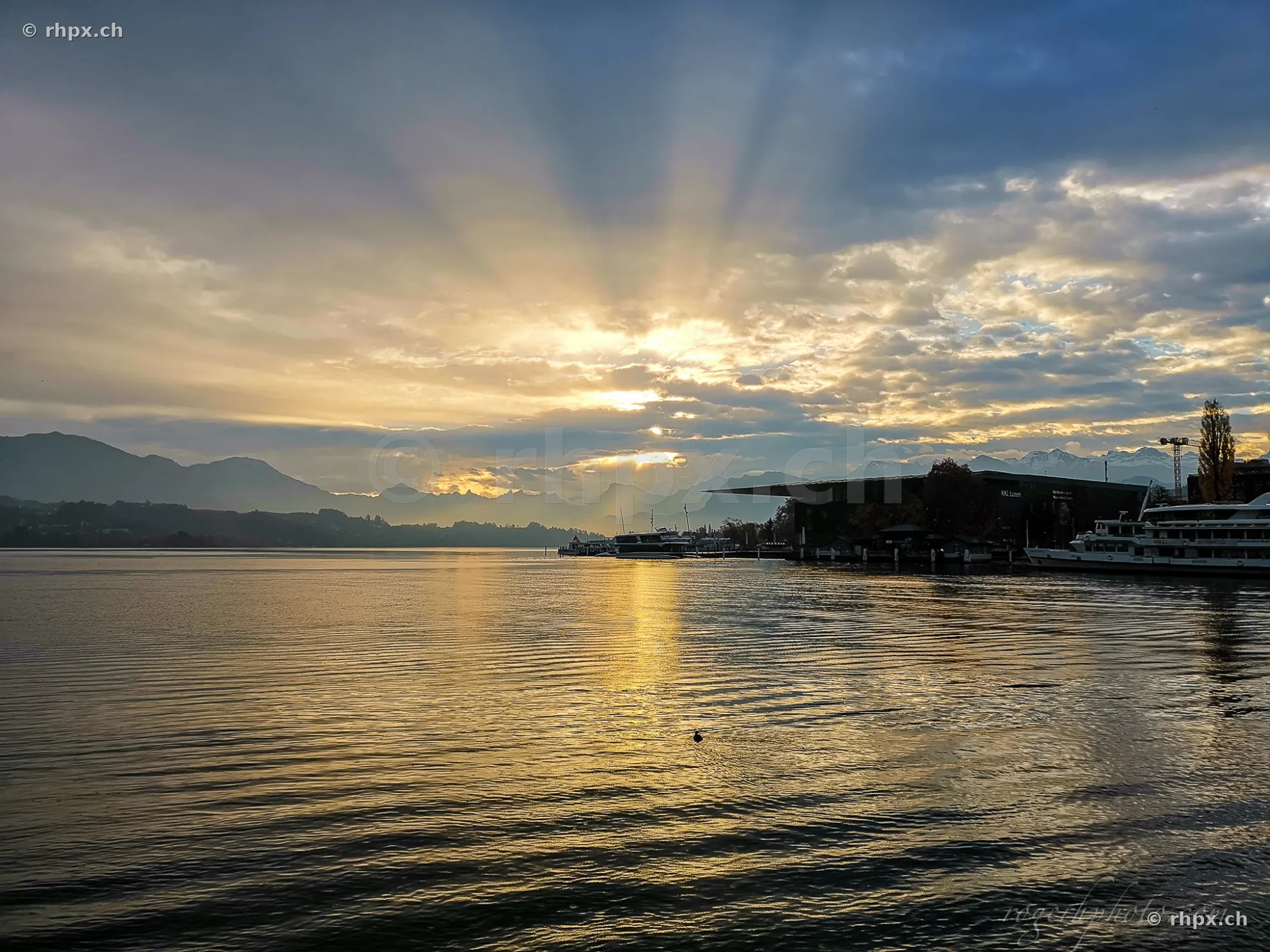 Sun rays over Lake Lucerne with the boat landing