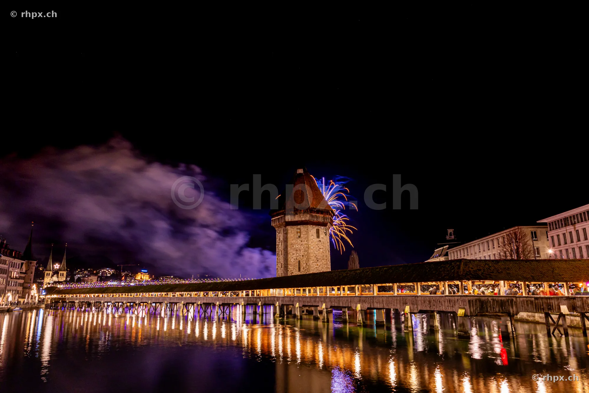 Chapel Bridge in Lucerne with New Year's fireworks at night