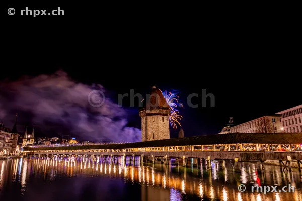 Chapel Bridge in Lucerne with New Year's fireworks at night