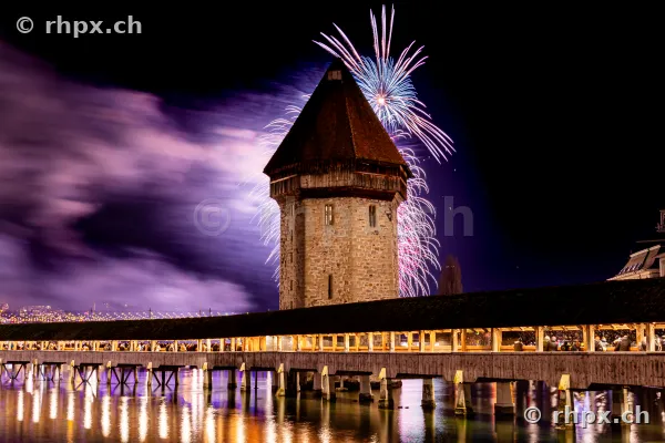 Fireworks above the Water Tower of the Chapel Bridge in Lucerne at night
