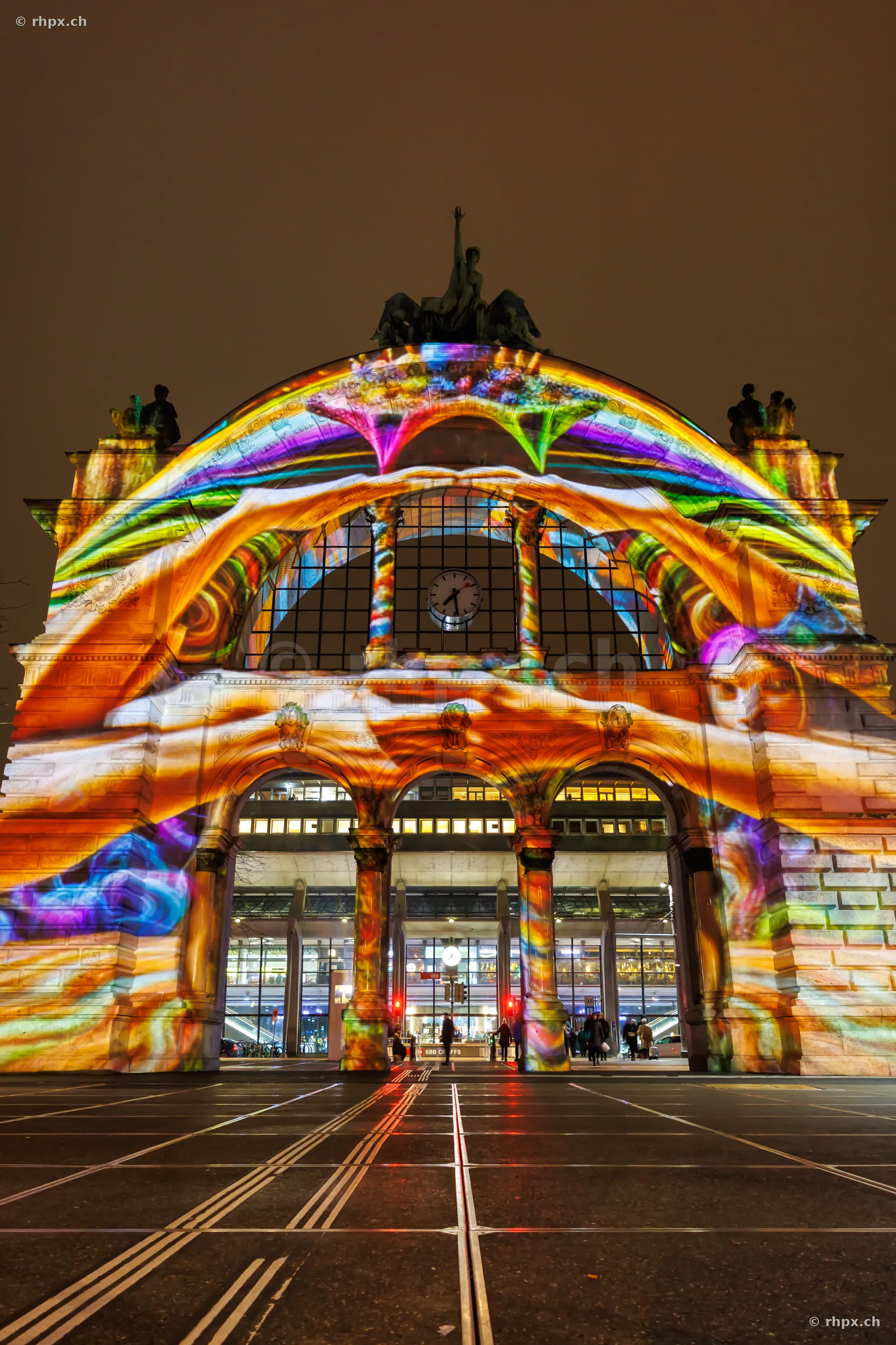 Colorful light projection on the gate of Lucerne railway station during Lilu festival