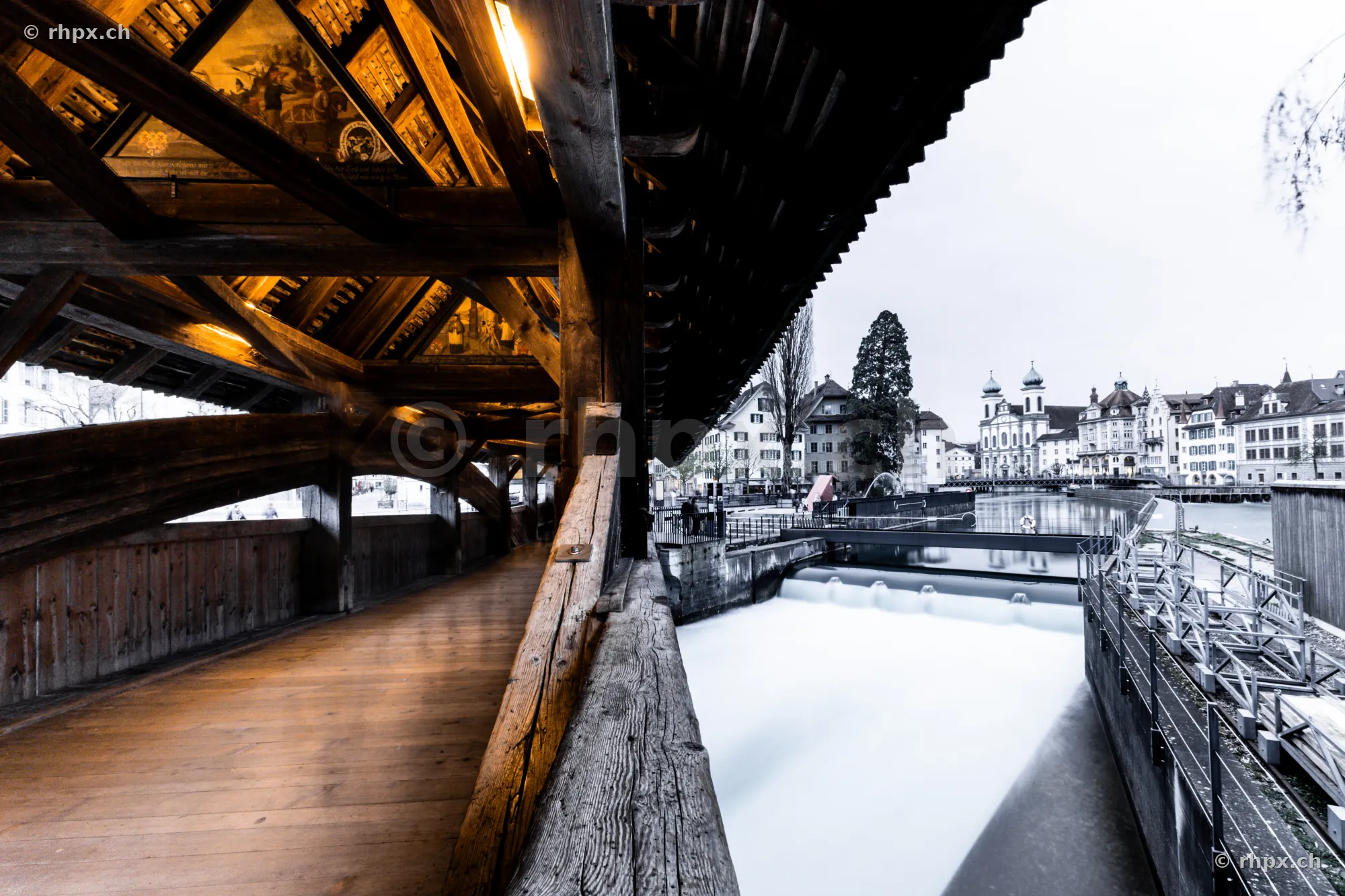 View from inside the Spreuer Bridge onto the Reuss River and the old town of Lucerne