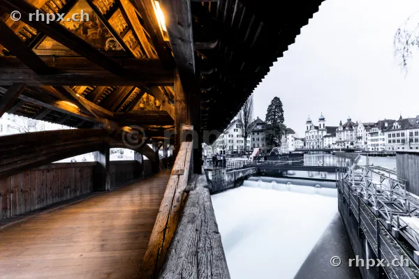 View from inside the Spreuer Bridge onto the Reuss River and the old town of Lucerne
