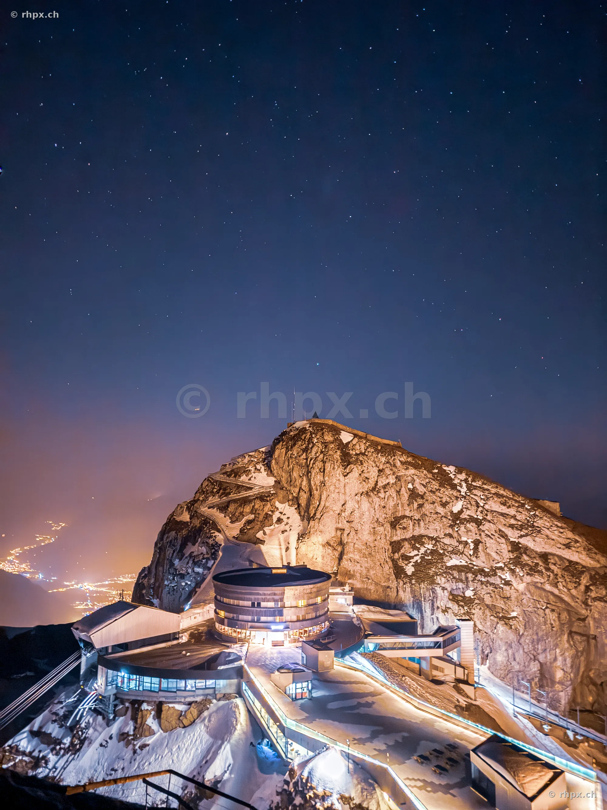 Night view of the Pilatus summit with hotel building and starry sky