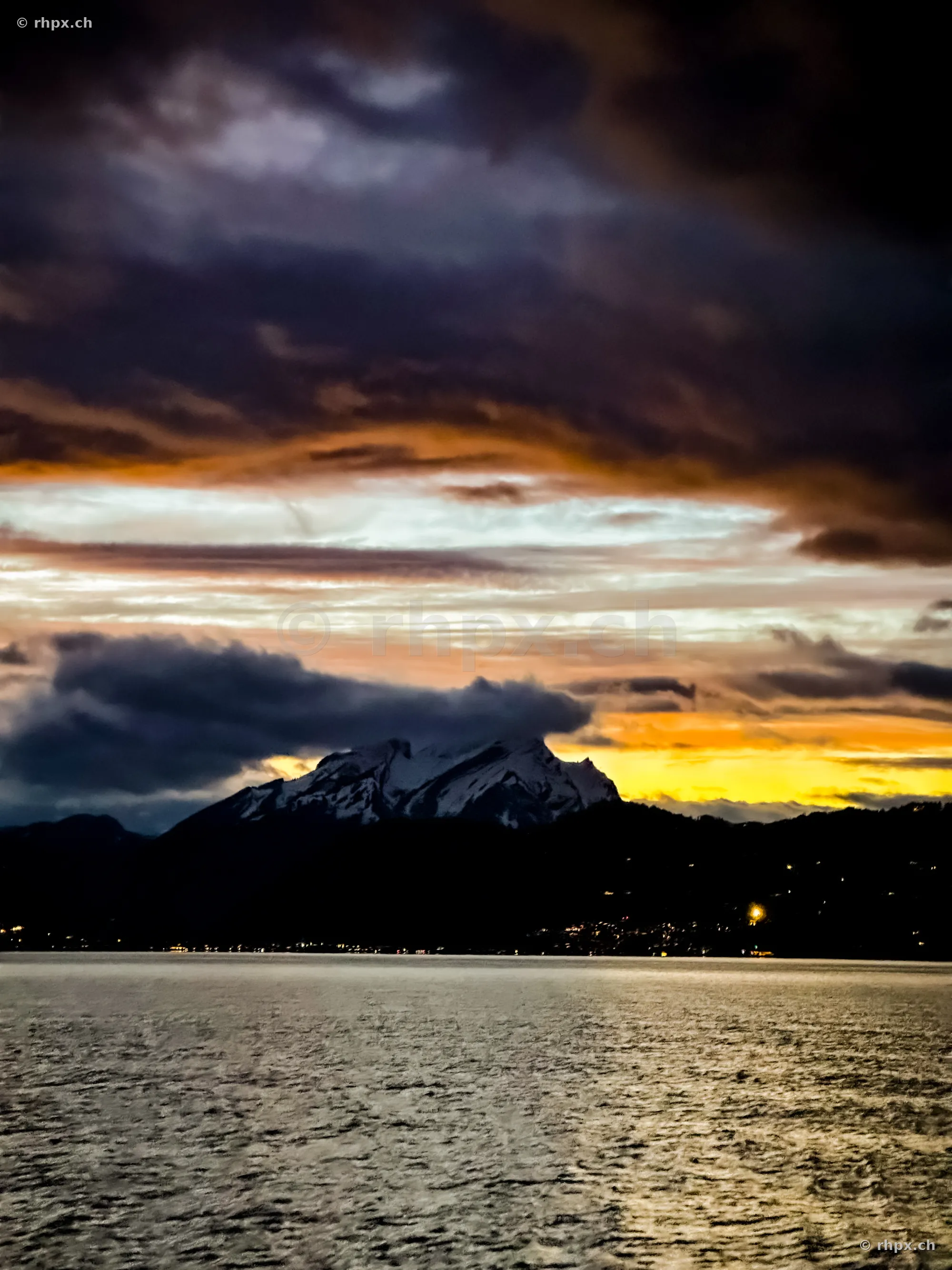 Mount Pilatus at sunset over Lake Lucerne with dramatic cloud formations