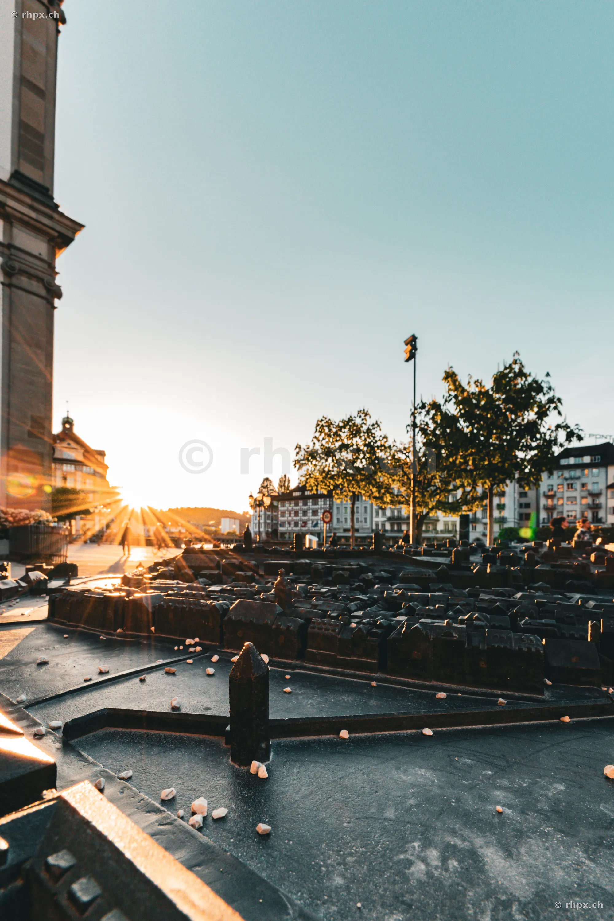 Bronze city model of Lucerne in front of the Jesuit Church at sunset