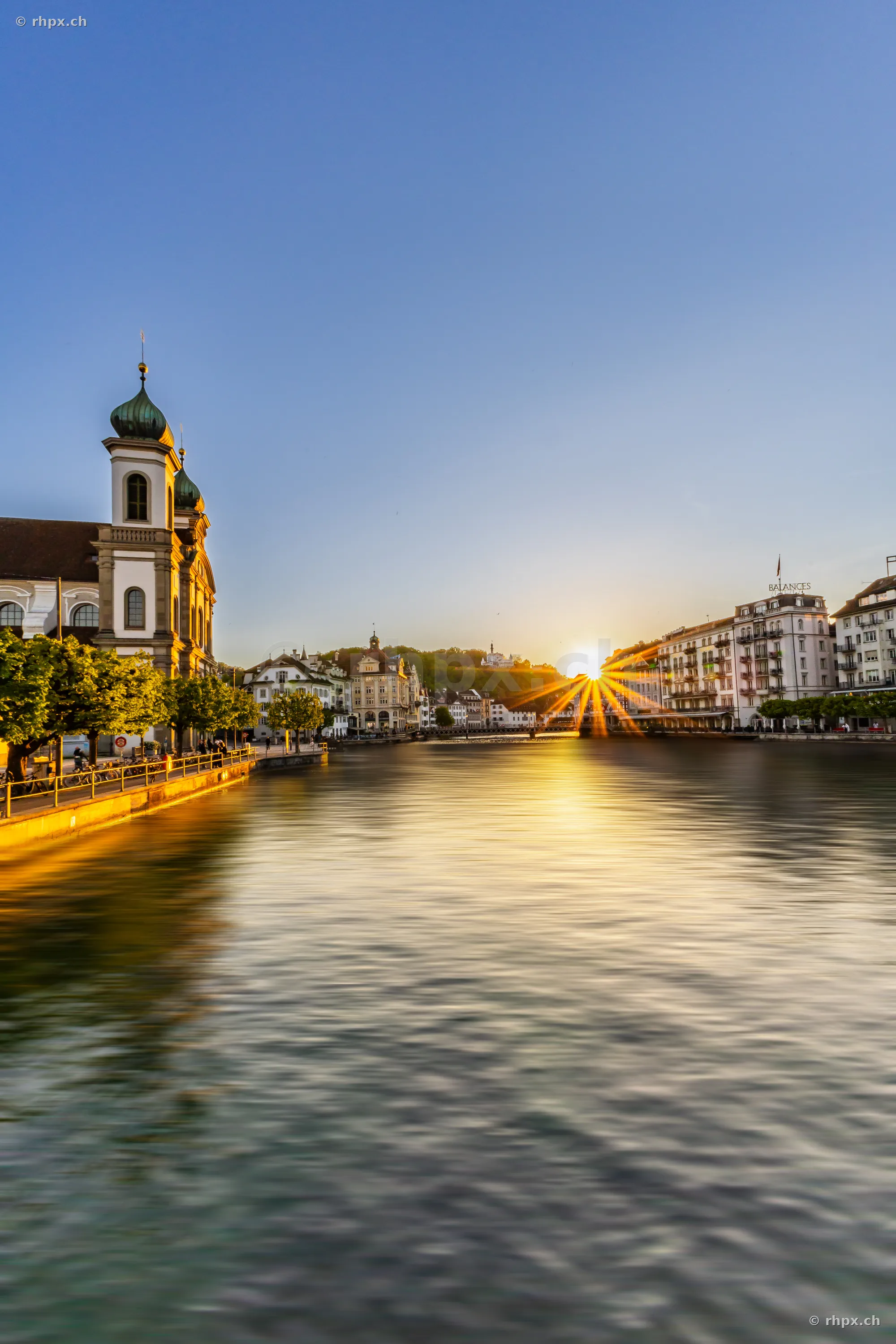 The Reuss river in Lucerne at sunset with the Jesuit Church on the bank