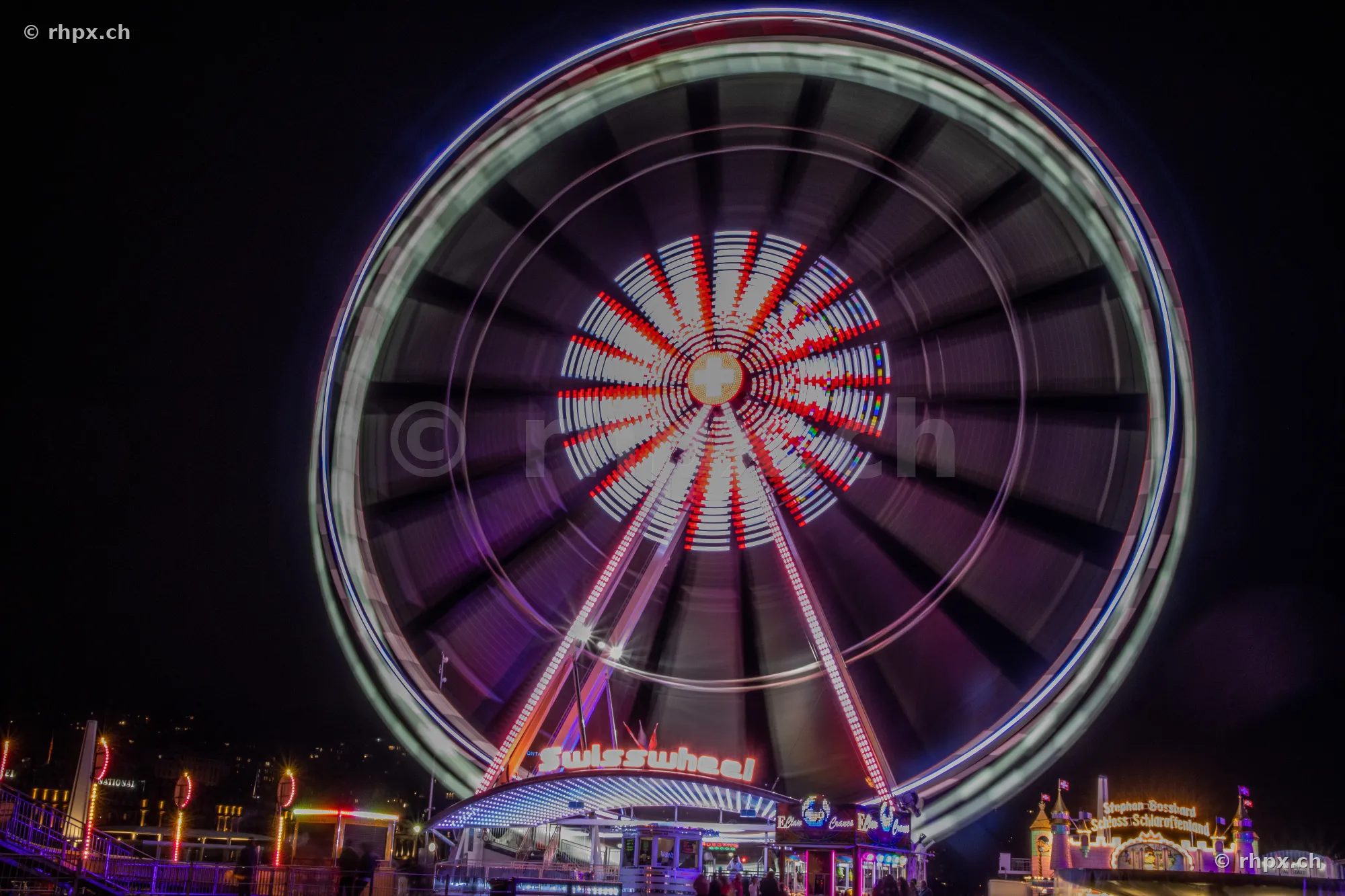 Swisswheel Ferris wheel with motion blur at night in Lucerne