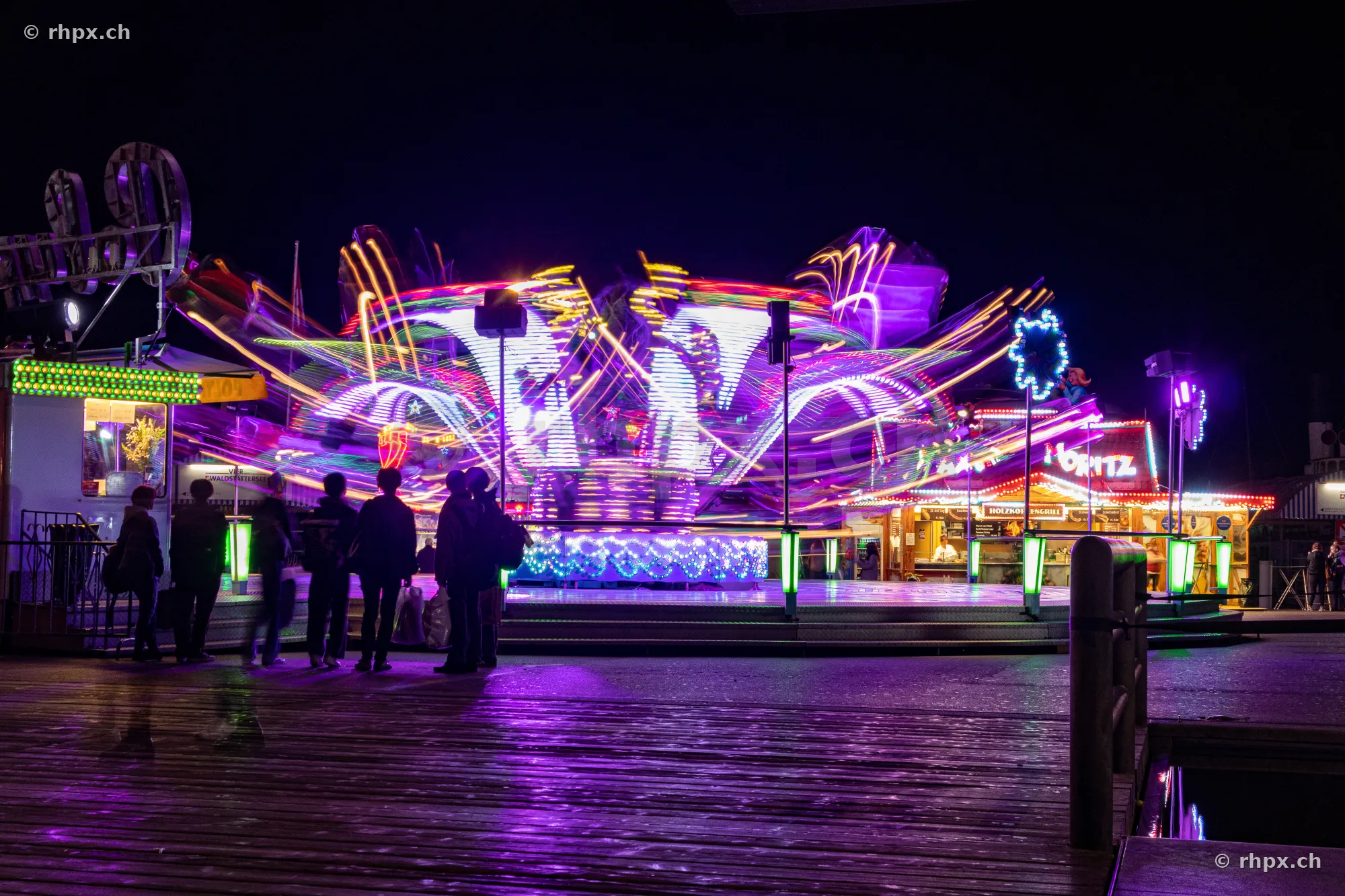 Long exposure of an illuminated funfair ride at night