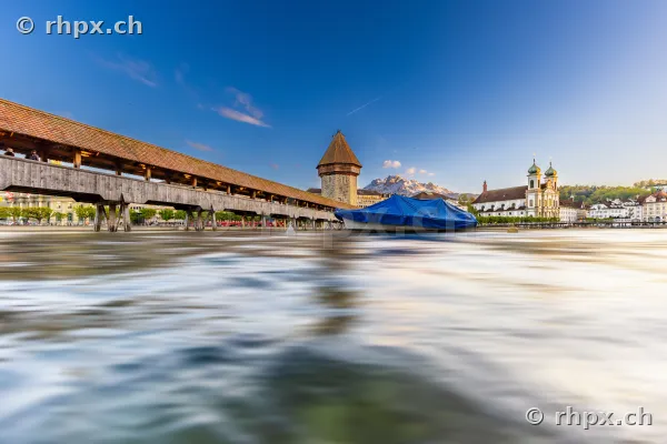 Chapel Bridge with water tower and Jesuit church in Lucerne in daylight