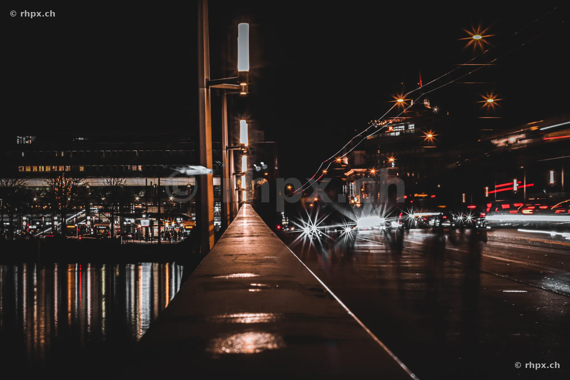 View along the Seebrücke in Lucerne at night with light trails from vehicles