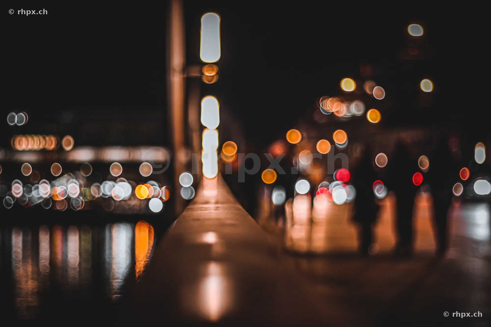 Blurred points of light along the waterfront promenade in Lucerne at night