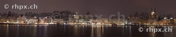 Panoramic view of the illuminated waterfront of Lucerne at night