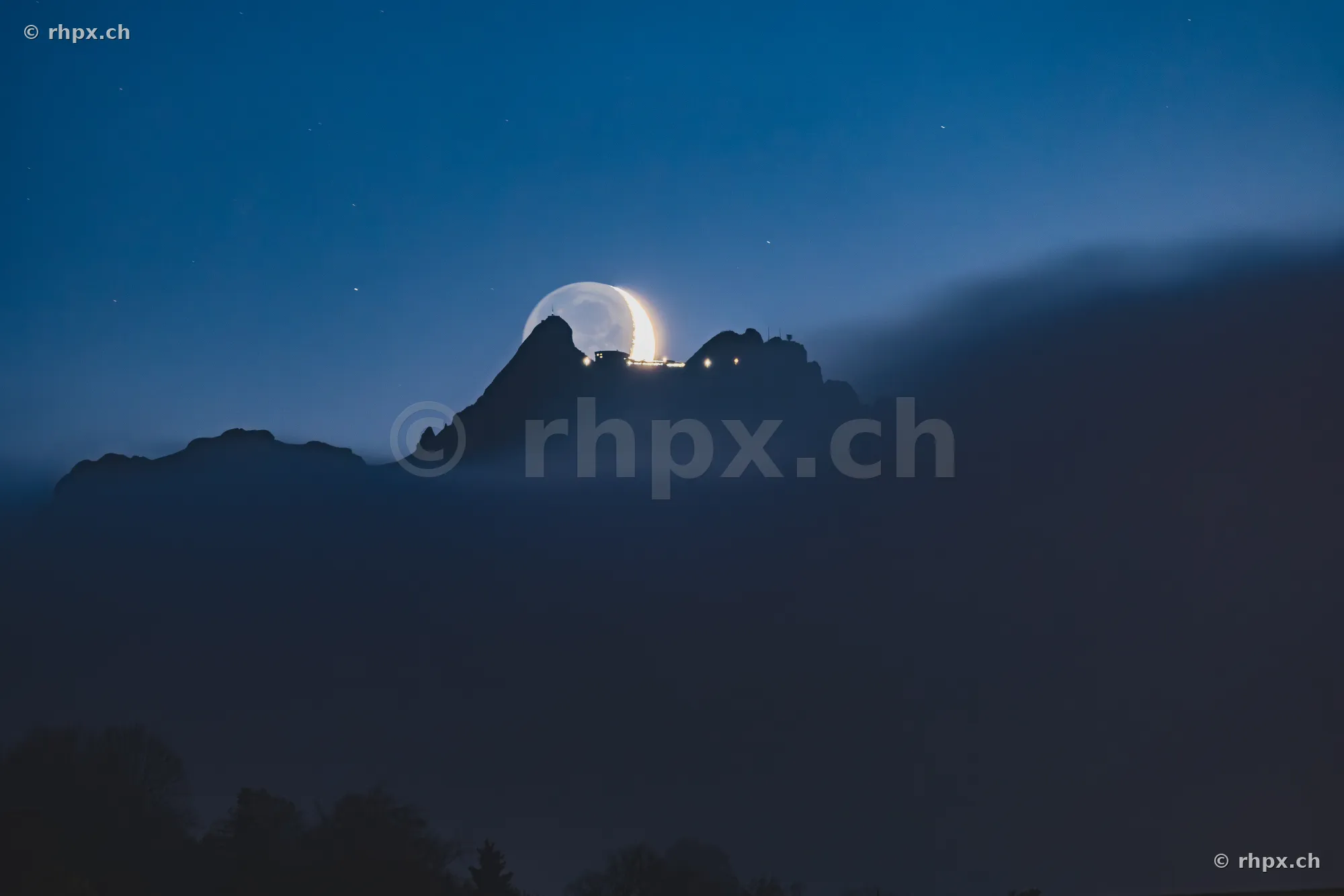 Crescent moon over the summit of Mount Pilatus near Lucerne at dusk