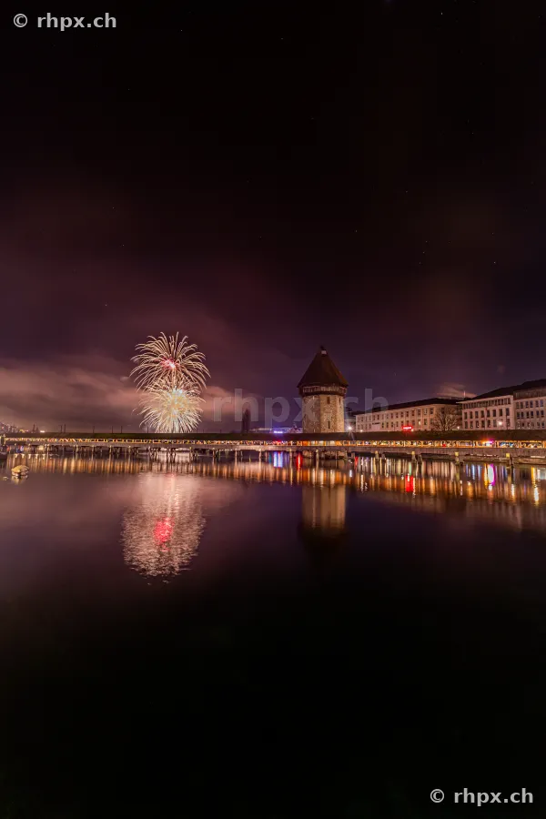 Fireworks in the night sky over the Chapel Bridge in Lucerne on January 1, 2025