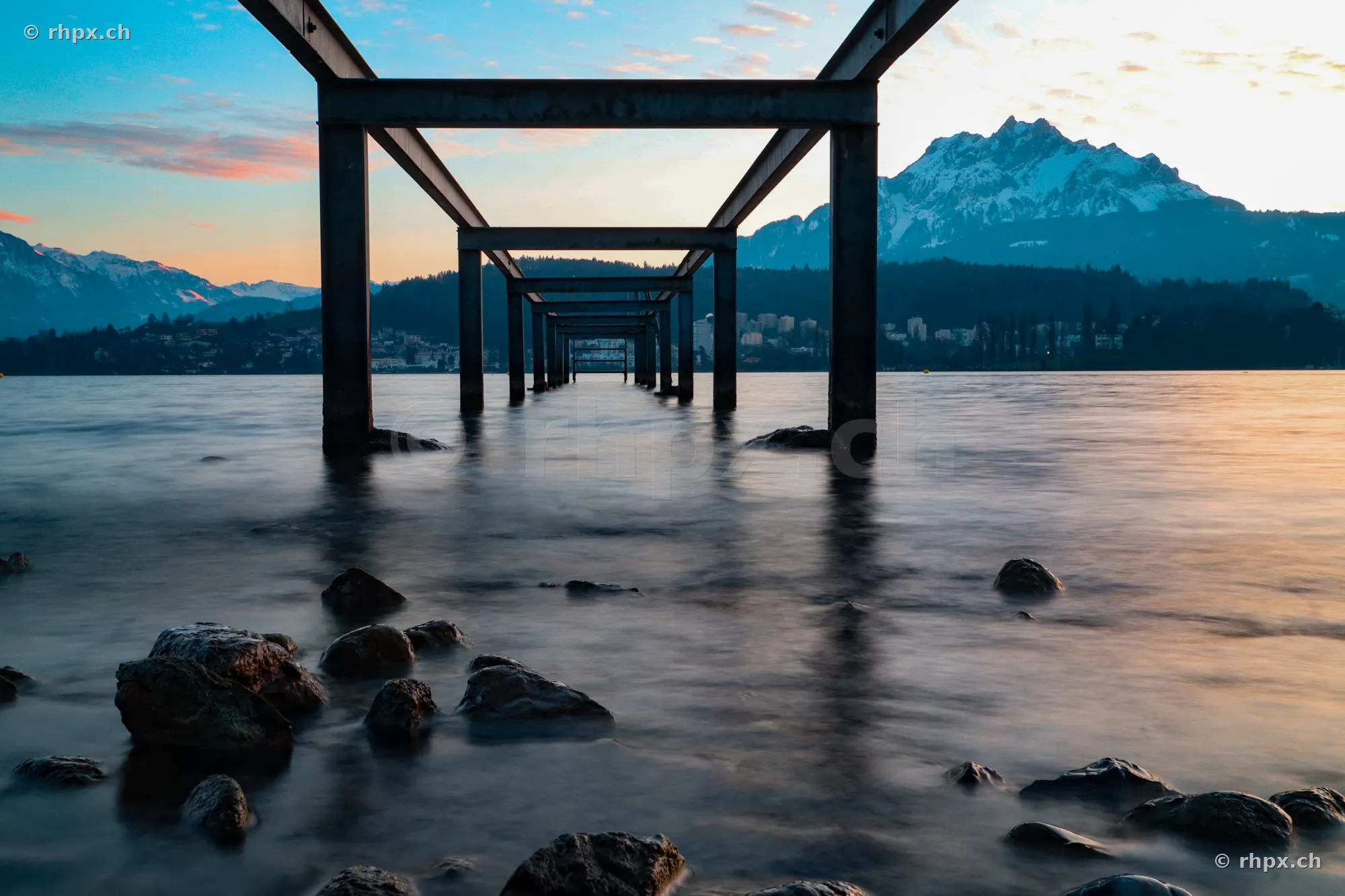 View through a steel frame standing in the water towards Mount Pilatus near Lucerne