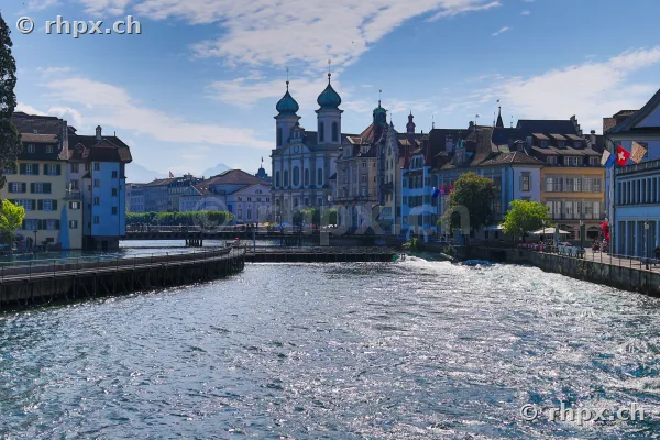 View of the Reuss river in Lucerne with the Hofkirche in the background