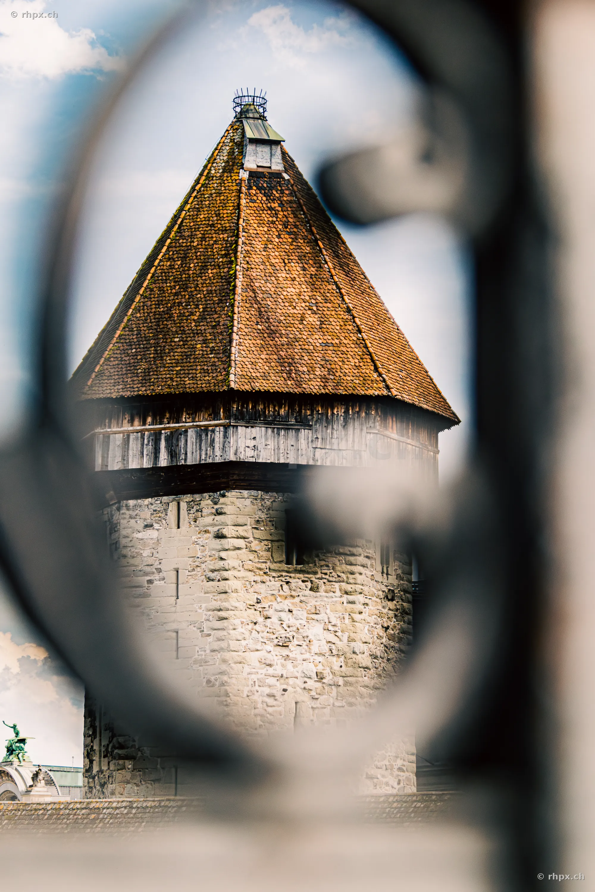 View of the Lucerne Water Tower through the opening of a metal railing