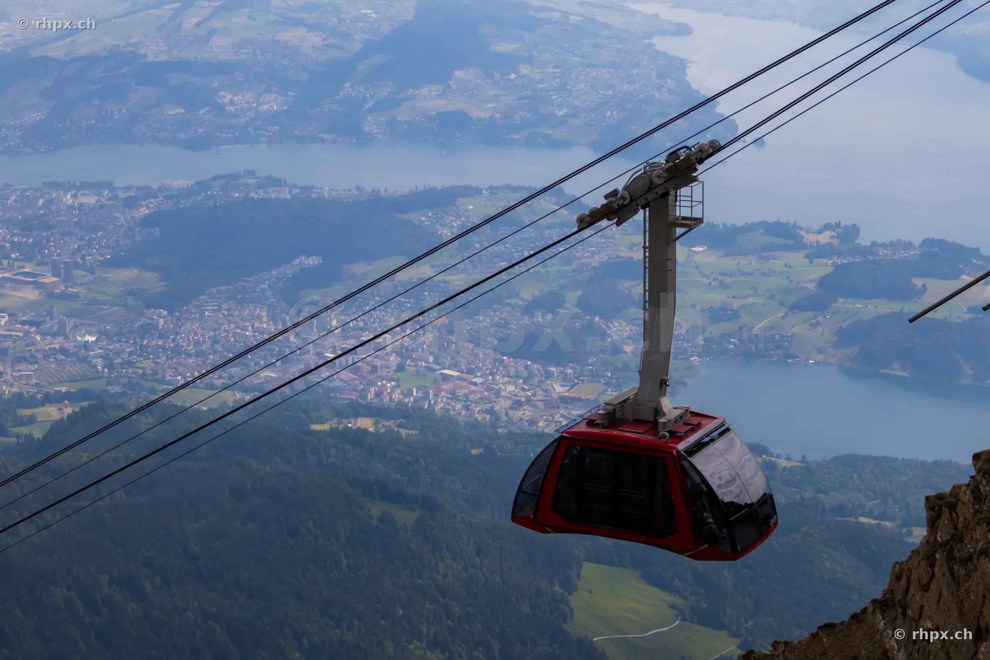 Red cable car on Mount Pilatus with a view of Lake Lucerne
