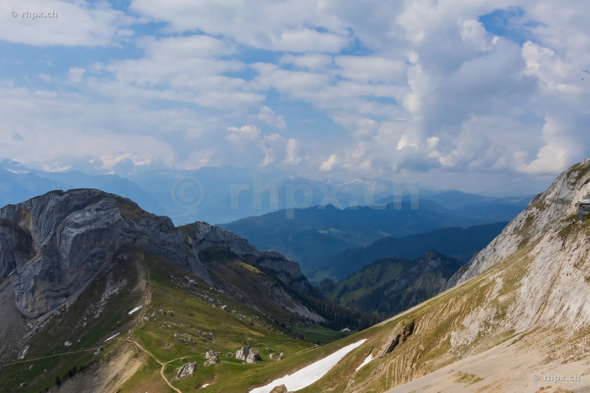 View from an elevation of the rugged rock faces and green slopes of Pilatus in summer weather