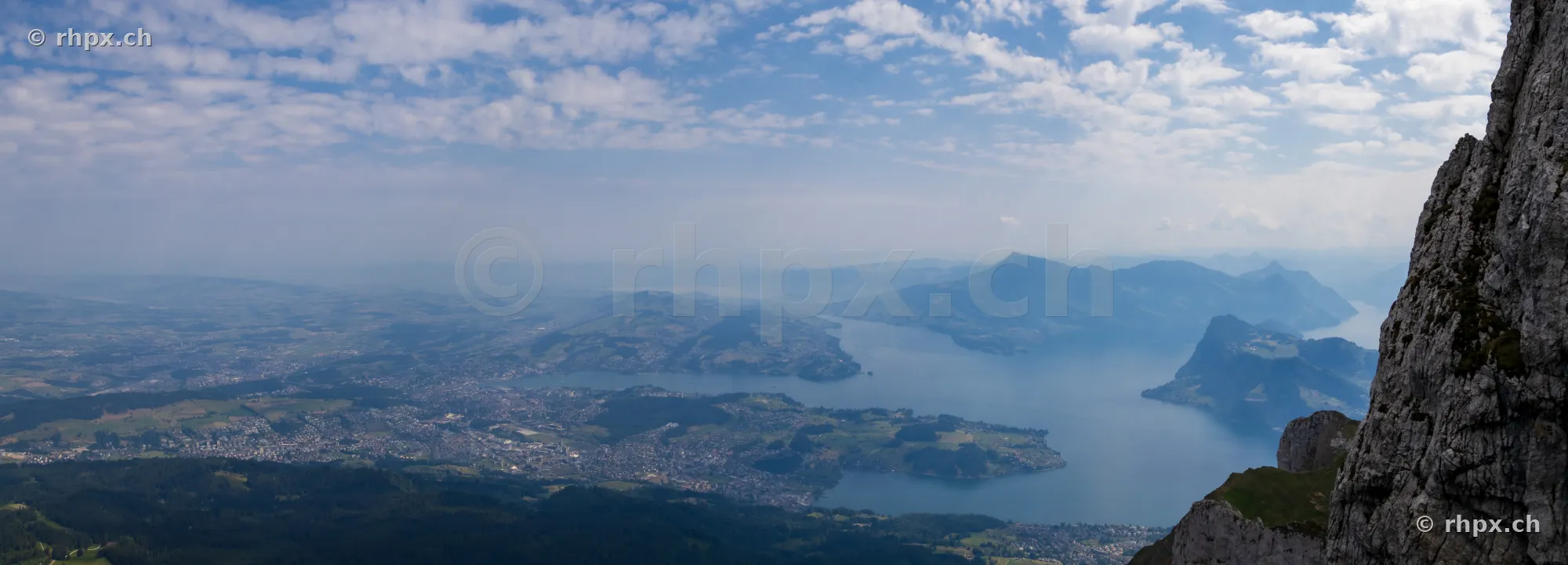 Panoramic view from Mount Pilatus overlooking Lucerne city and Lake Lucerne on a bright day