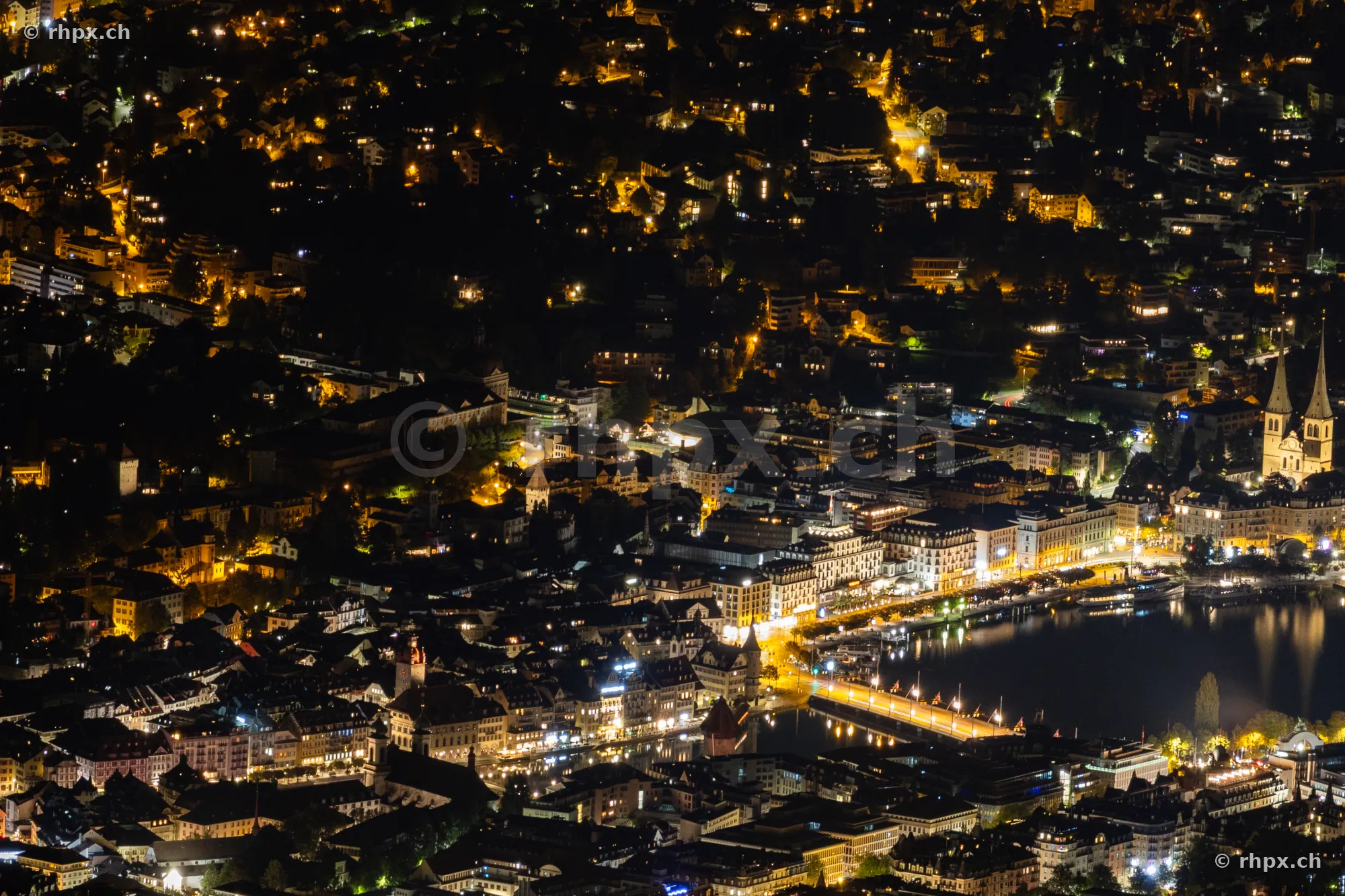 Night view of the illuminated city of Lucerne from Mount Pilatus