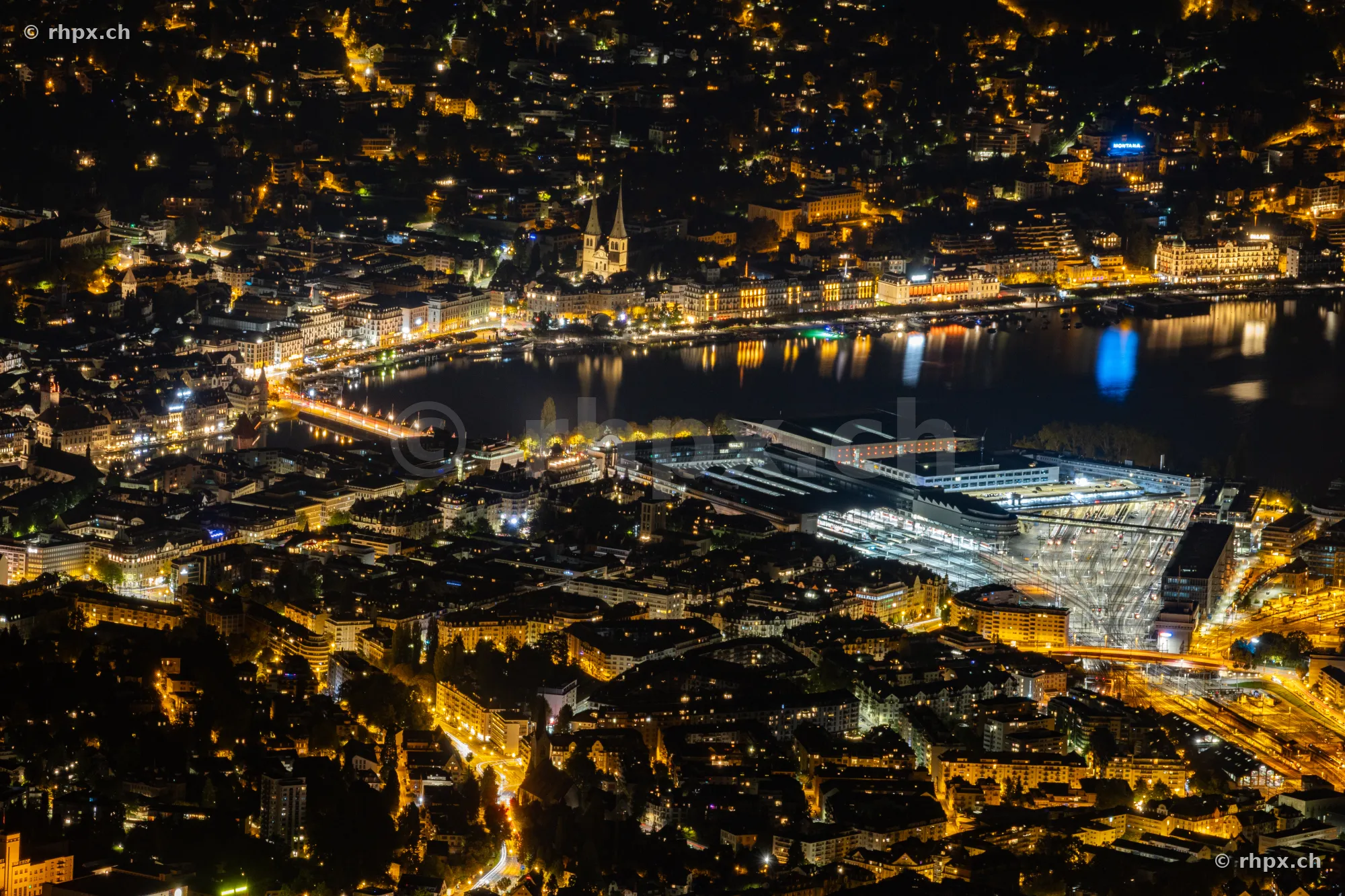 Aerial night view of Lucerne with Lake Lucerne and the train station