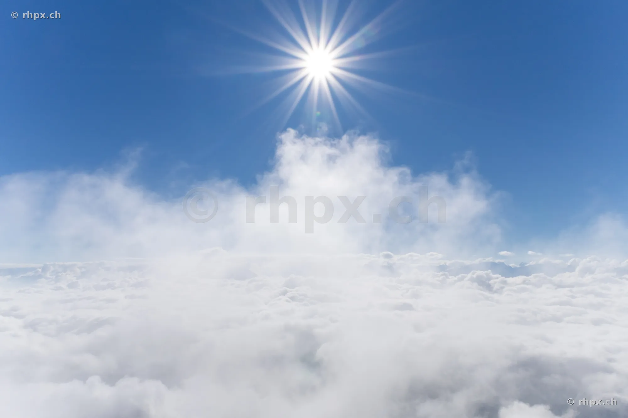 View over a solid cloud cover with bright sunshine near Mount Pilatus