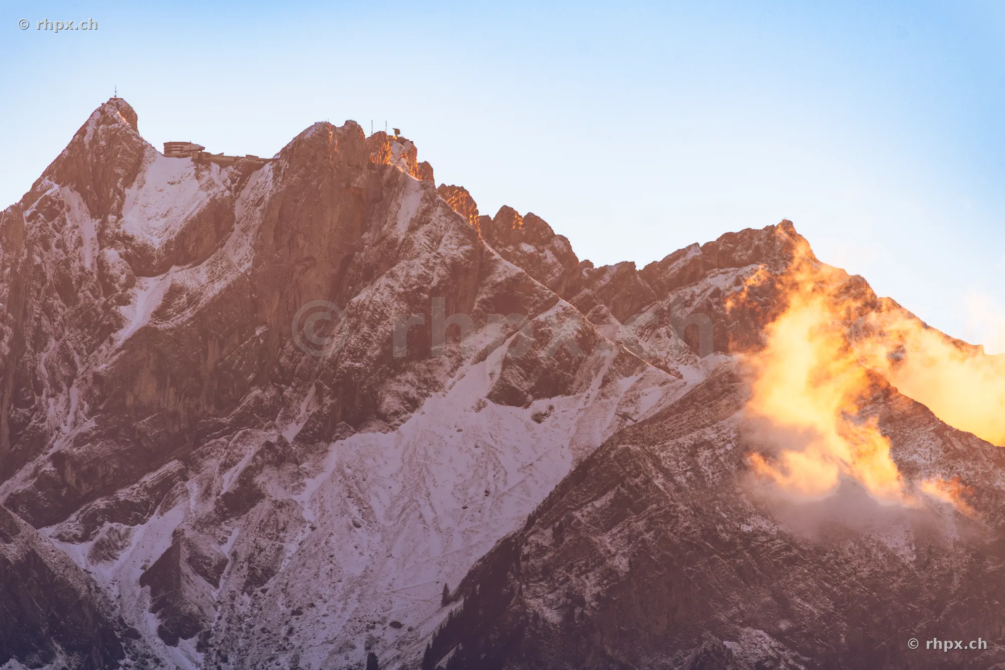 View of the Pilatus massif with snow and cloud-covered rock faces at dusk