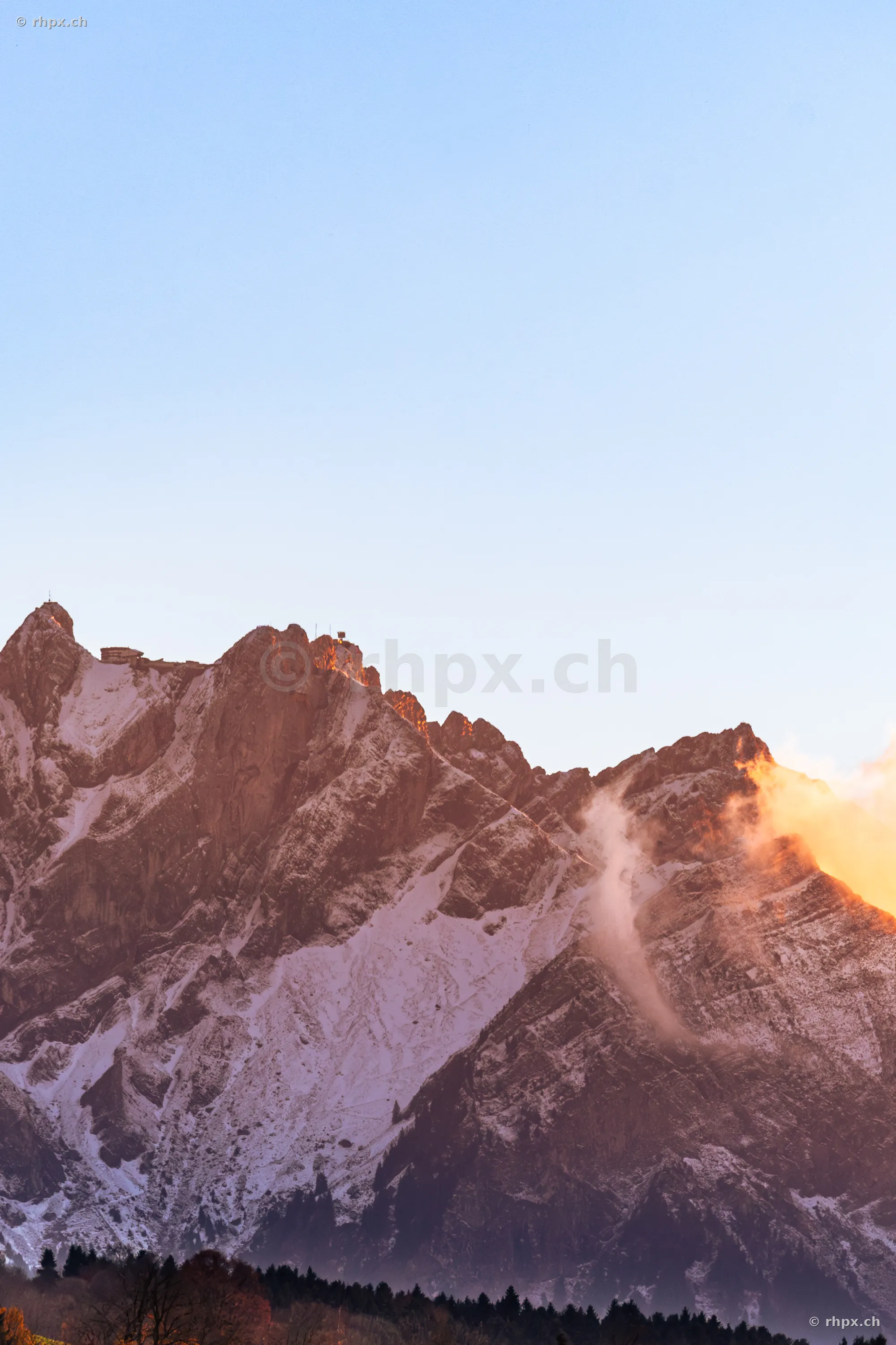The snow-covered peak of Mount Pilatus in Central Switzerland during sunset.