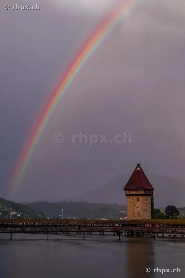 Rainbow over the Chapel Bridge and Wasserturm in Lucerne during rainy weather