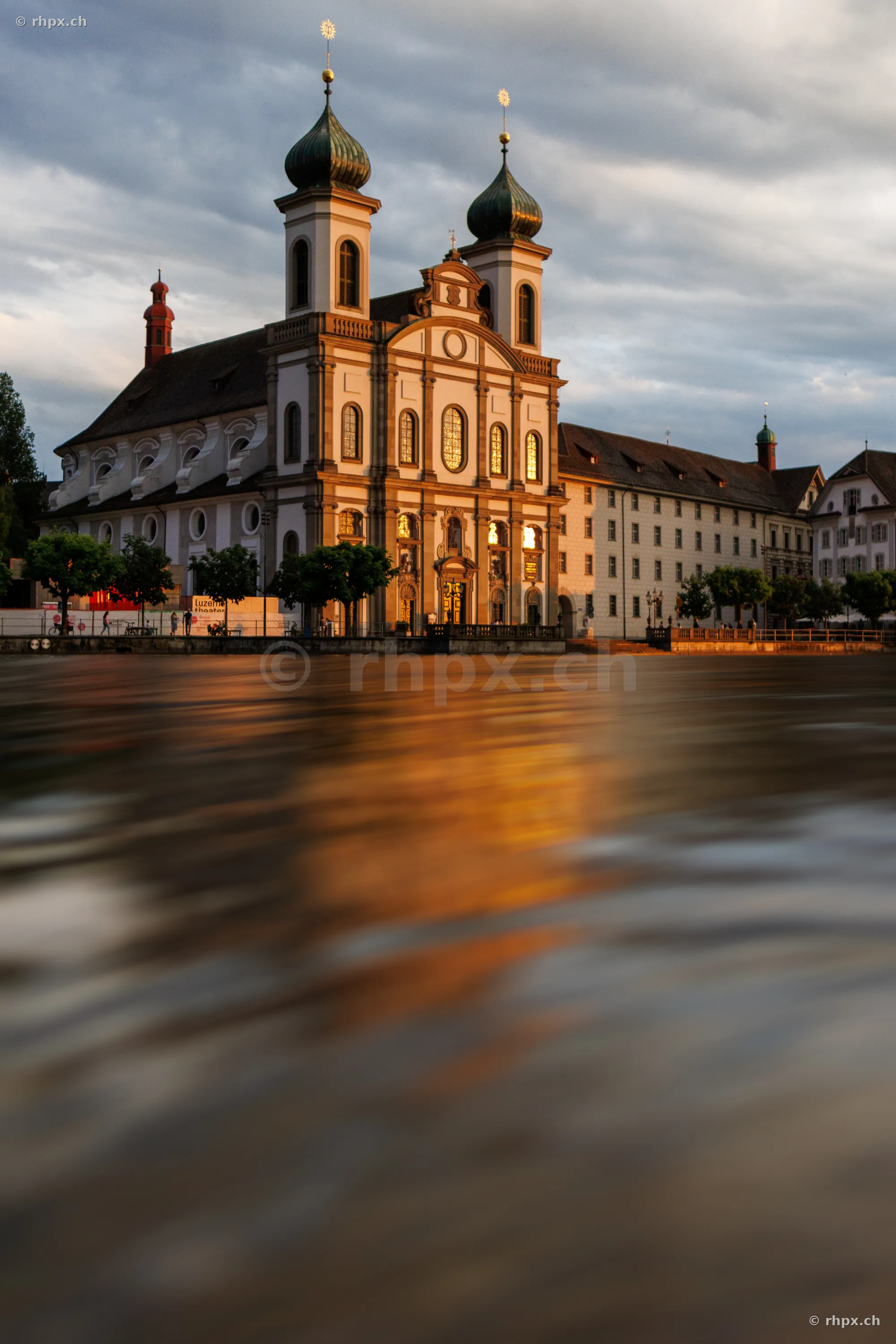 Jesuit Church in Lucerne with Reuss river in foreground at sunset