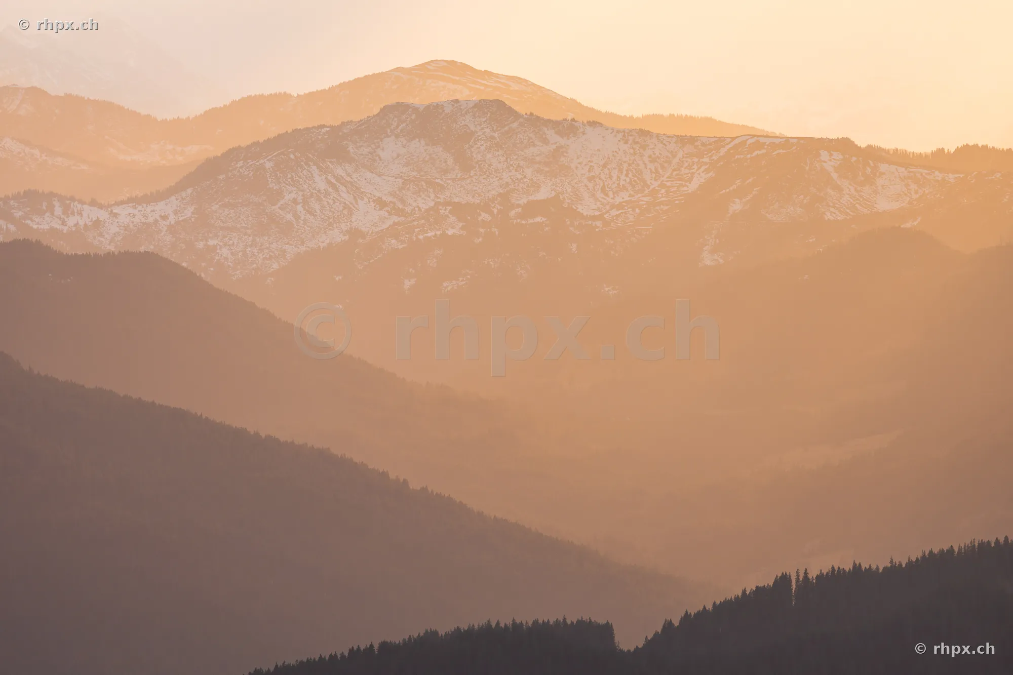 View of the snow-capped Mount Pilatus in the Central Swiss Alps at sunset.