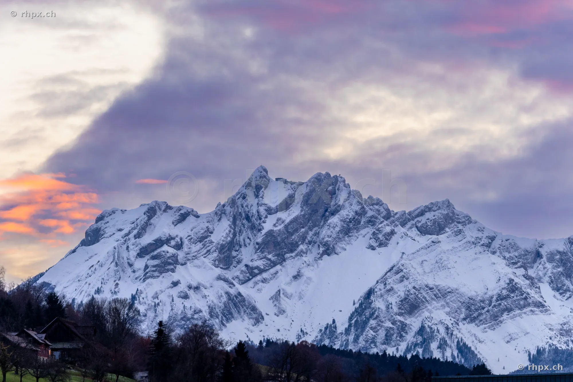 The snow-covered massif of Mount Pilatus near Lucerne against a cloudy evening sky