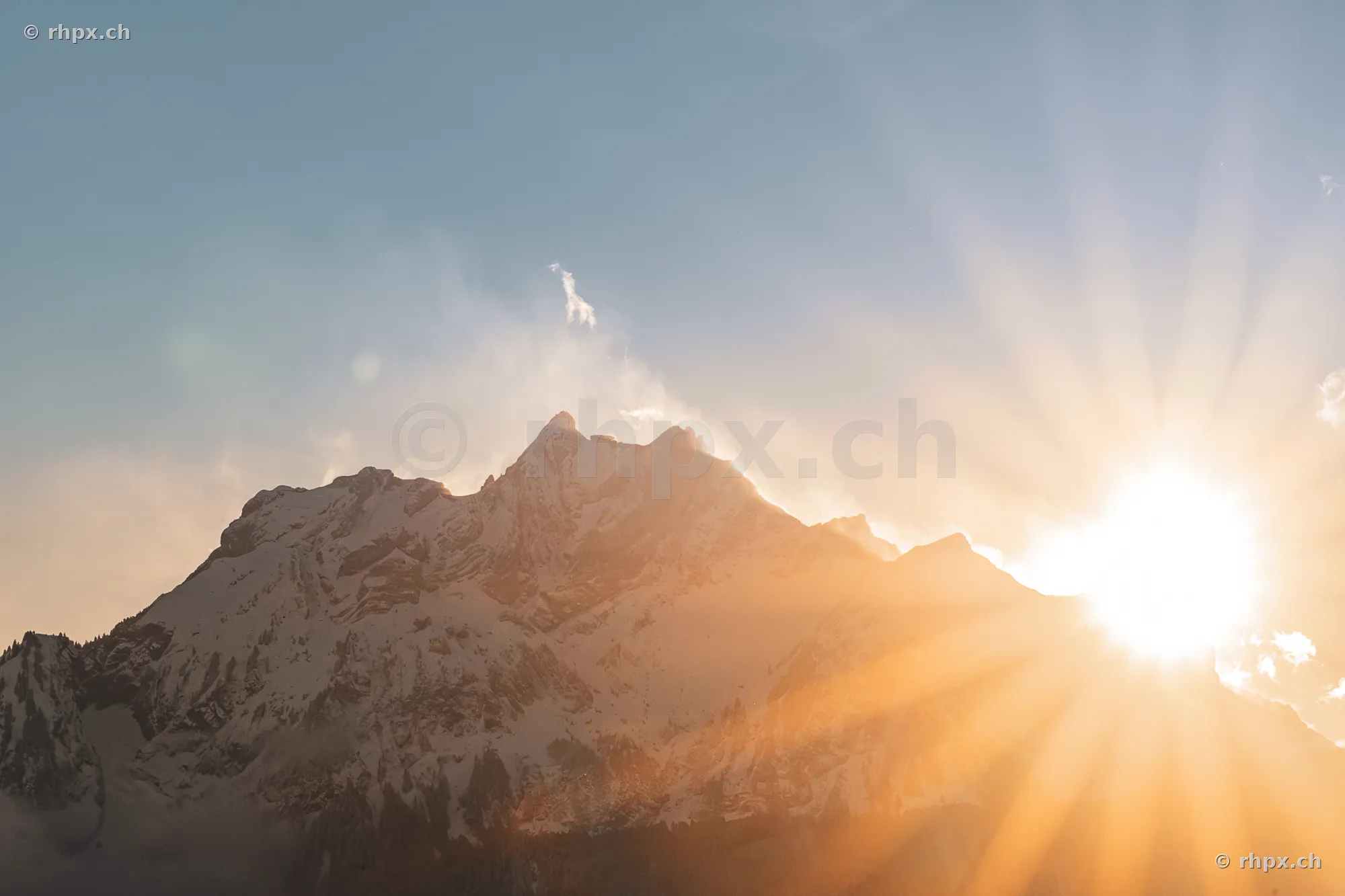 The summit area of Mount Pilatus at sunset with backlit sun