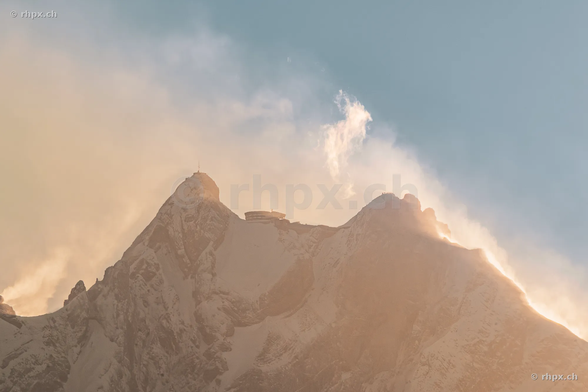 View of the summit of Mount Pilatus with the Bellevue hotel and passing clouds.