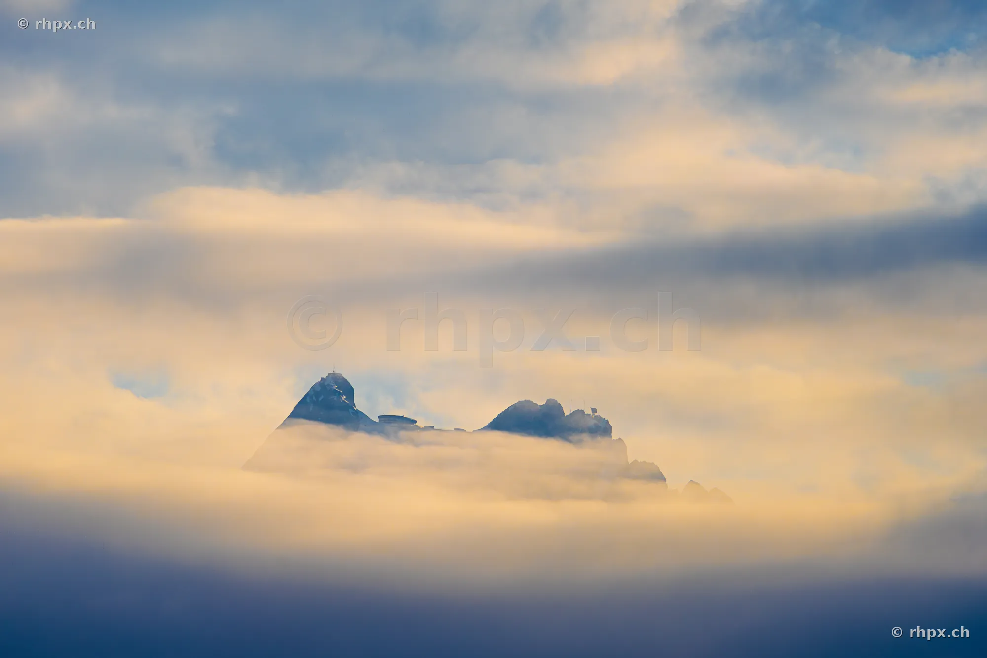 The summit of Mount Pilatus near Lucerne emerging partially from thick cloud layers