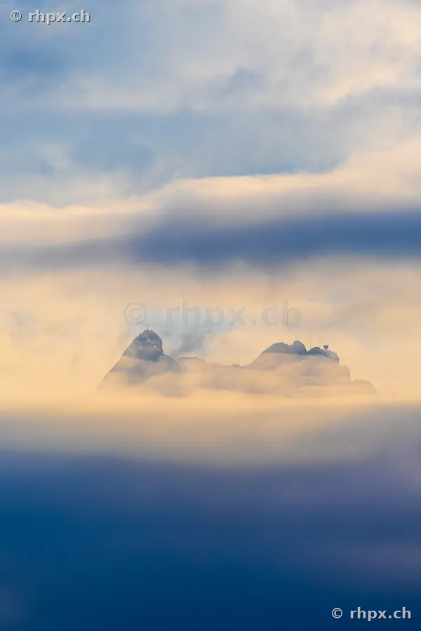 Der Gipfelbereich des Pilatus umgeben von Wolken und Nebel bei weichem Licht