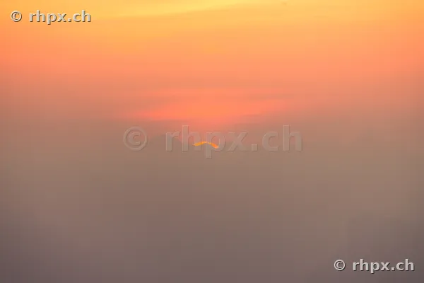 Sun disc just before disappearing behind the Pilatus massif in Central Switzerland.