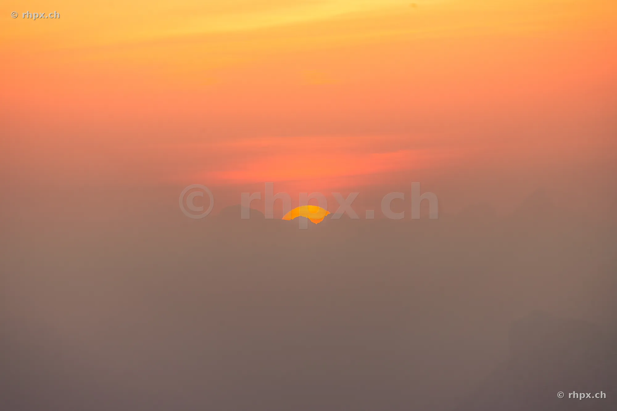 Silhouette of the Pilatus massif in Central Switzerland during an orange sunset