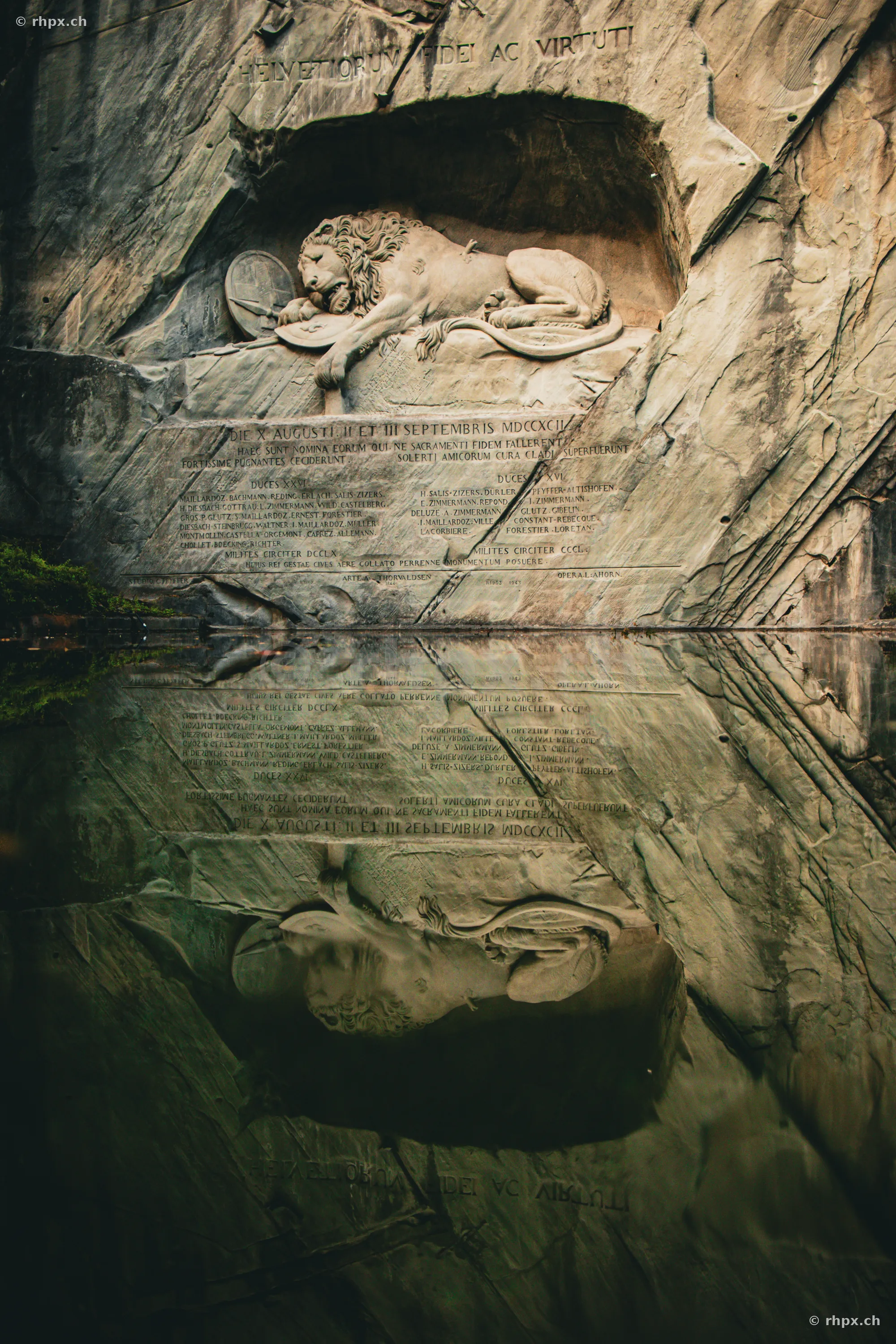 The Lion Monument in Lucerne with the reflection of the rock wall in the water