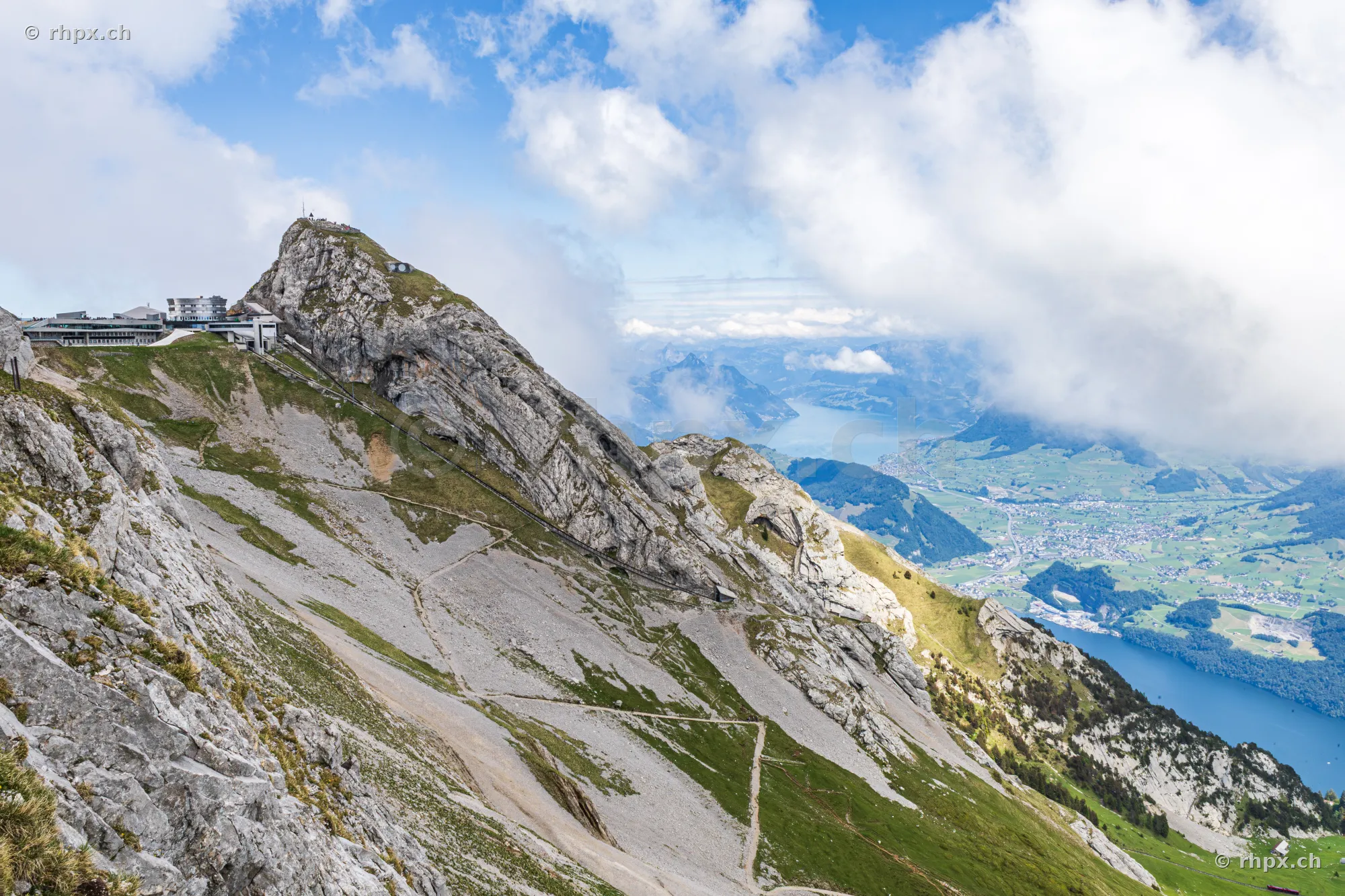View of the Pilatus summit with hotel and a panorama of the Central Swiss lake landscape