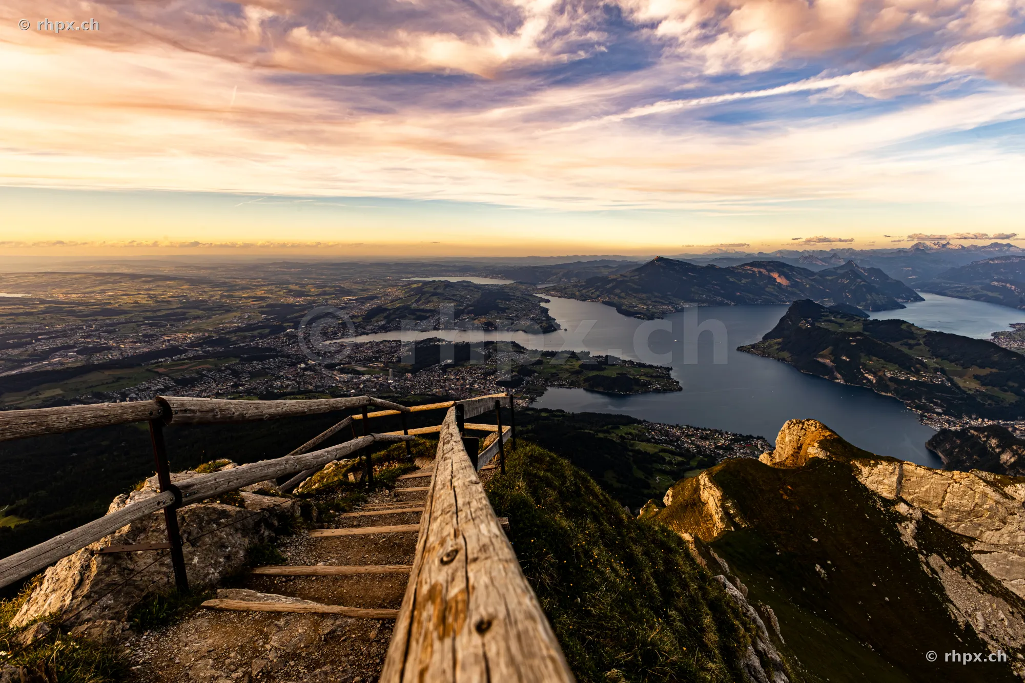 View from a wooden railing on Mount Pilatus over Lake Lucerne at sunset