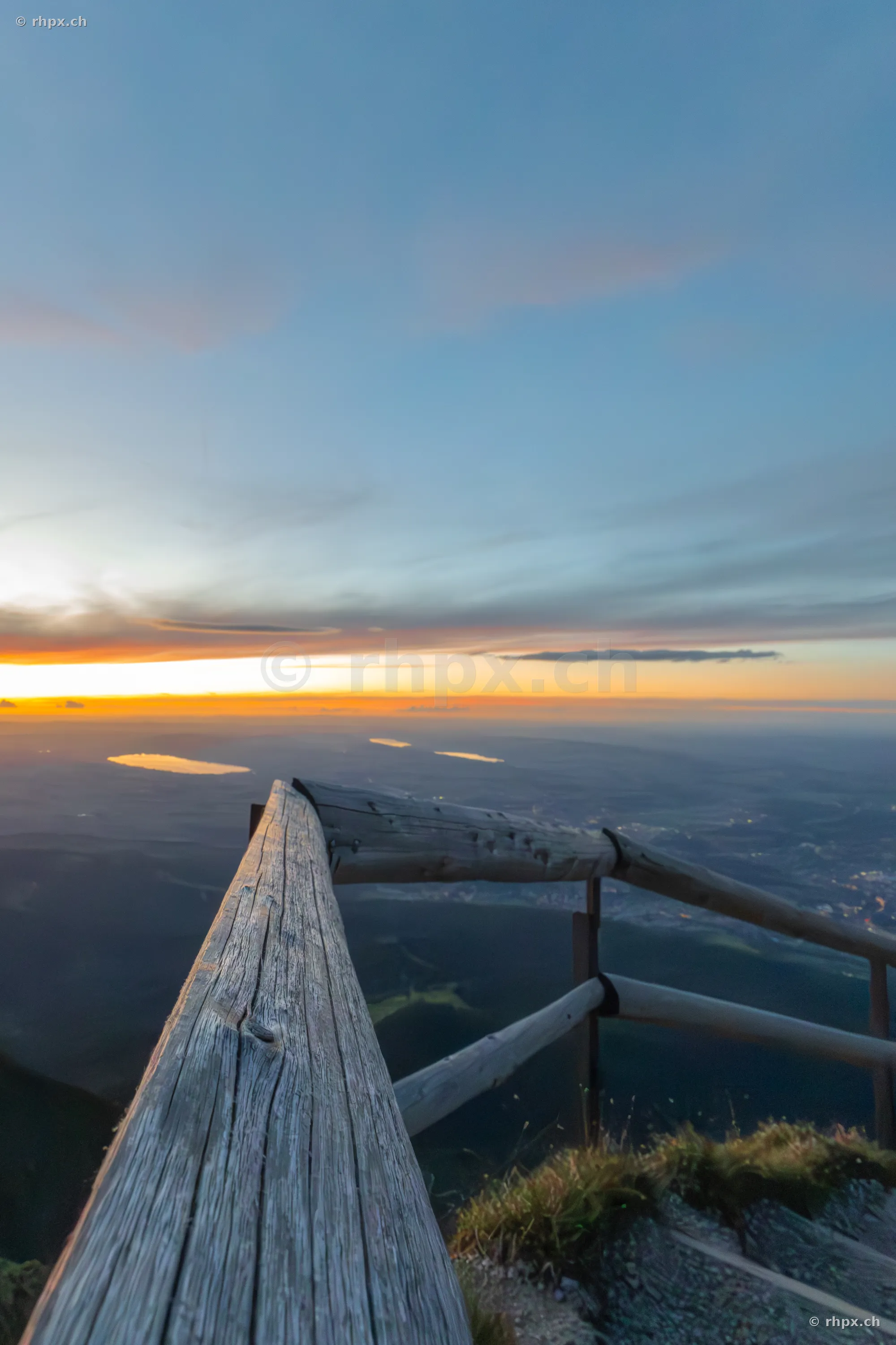 Wooden railing on Mount Pilatus in front of the evening horizon