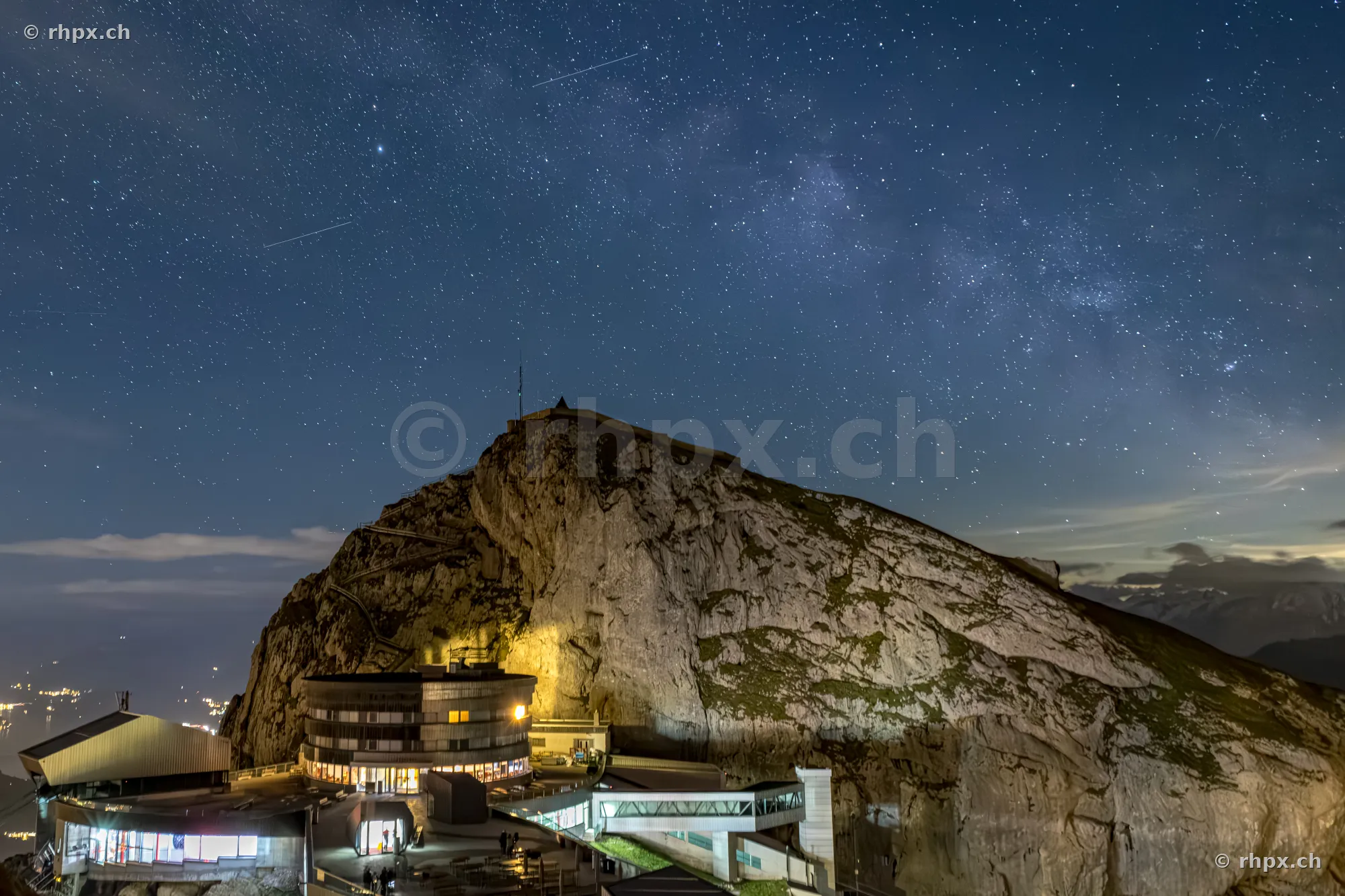 Night view of the Hotel Pilatus Kulm against a starry sky with the Milky Way