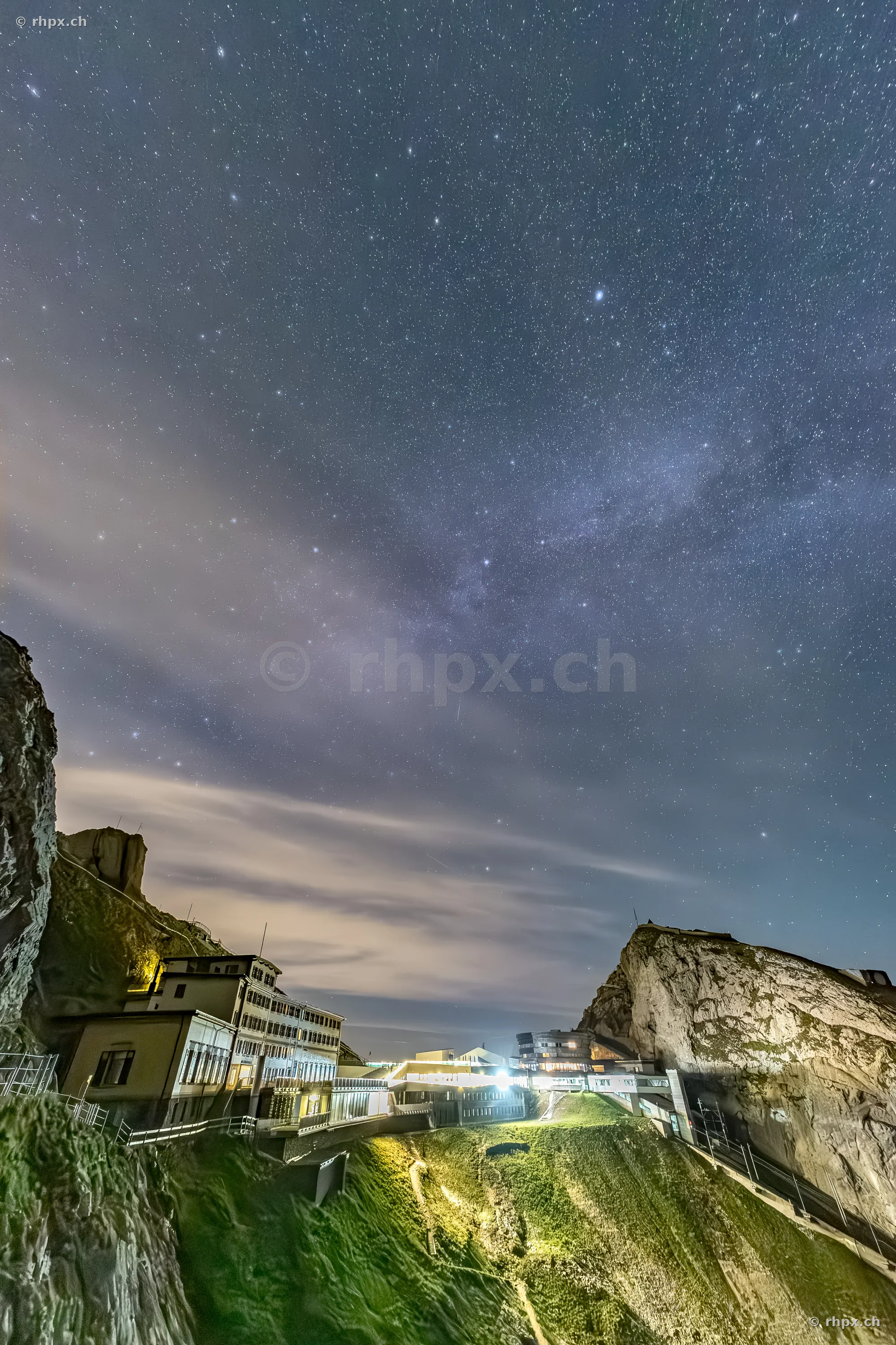 Night view of the hotel facilities on Mount Pilatus under a clear starry sky with the visible Milky Way.