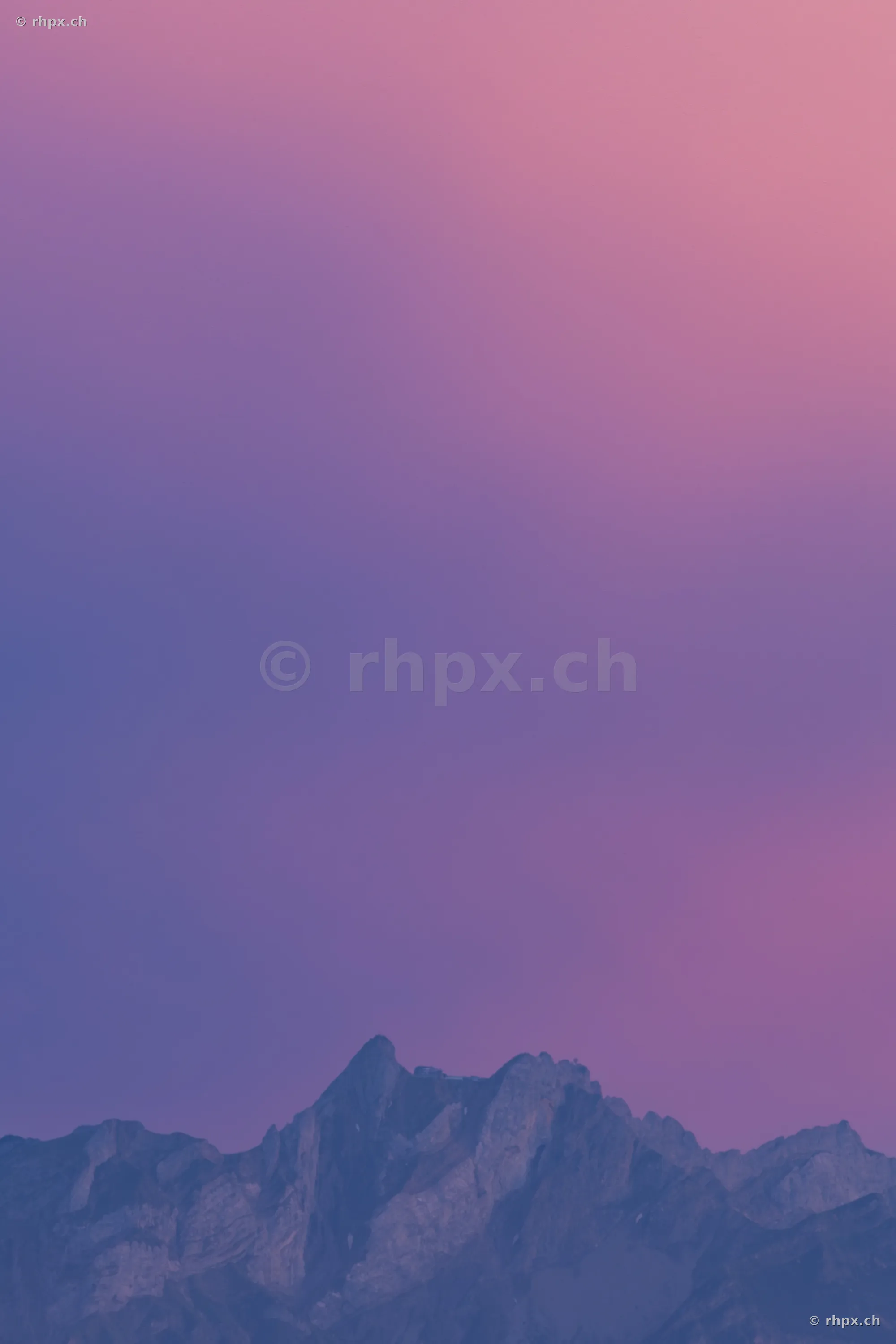Silhouette of the Pilatus massif against a violet evening sky