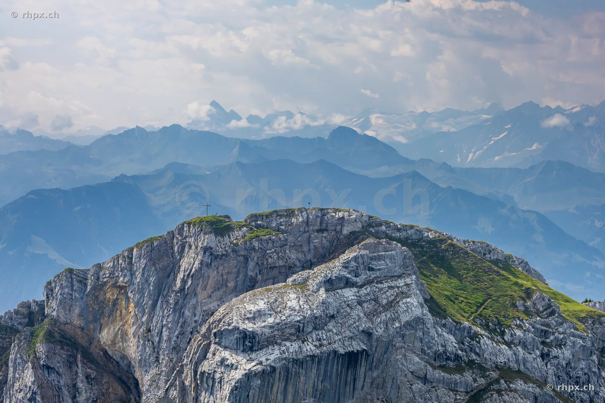View of the prominent Pilatus rock massif with its summit and the Alps in the background.